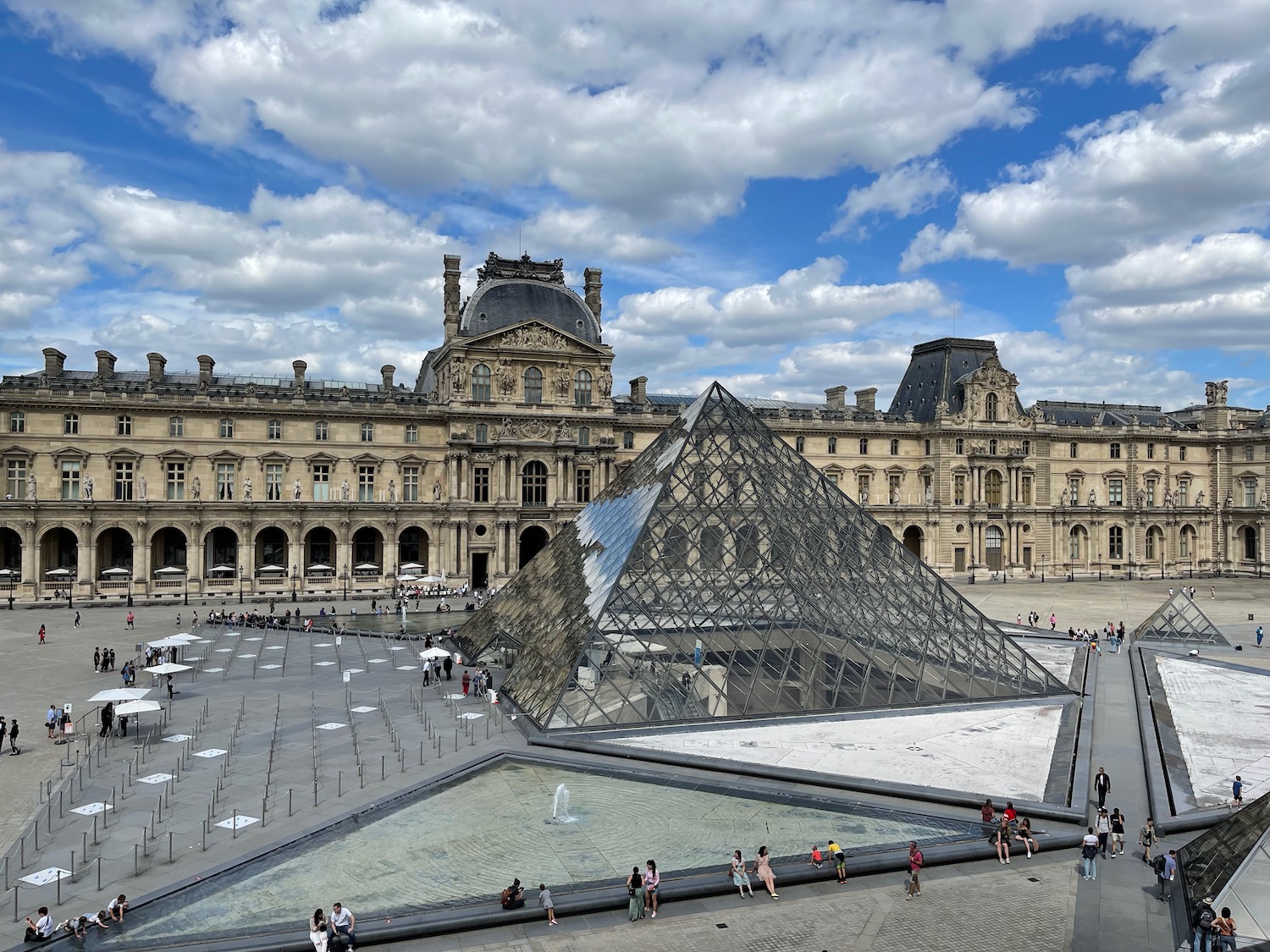 a glass pyramid in front of Louvre