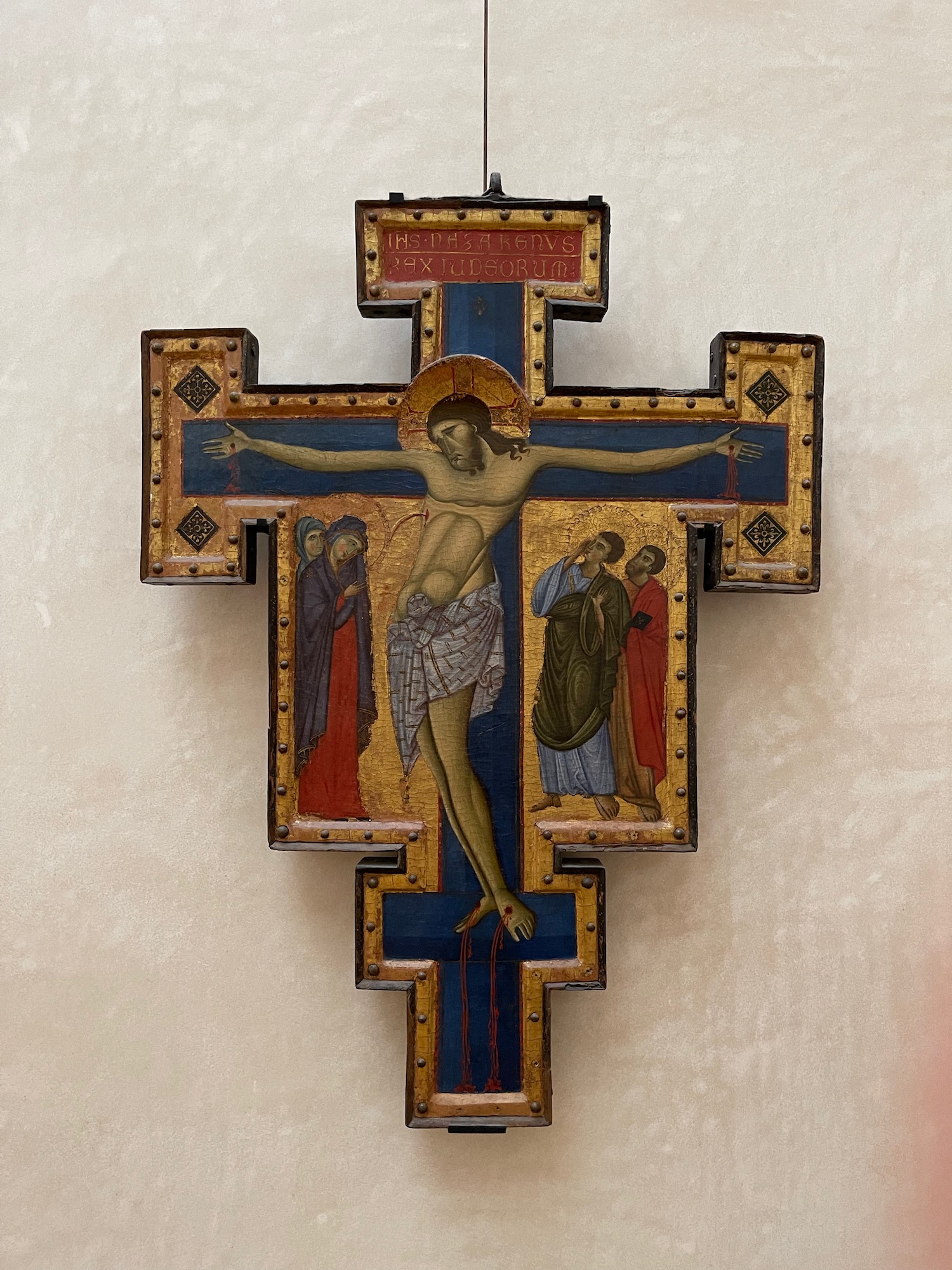 a cross with a painting on it