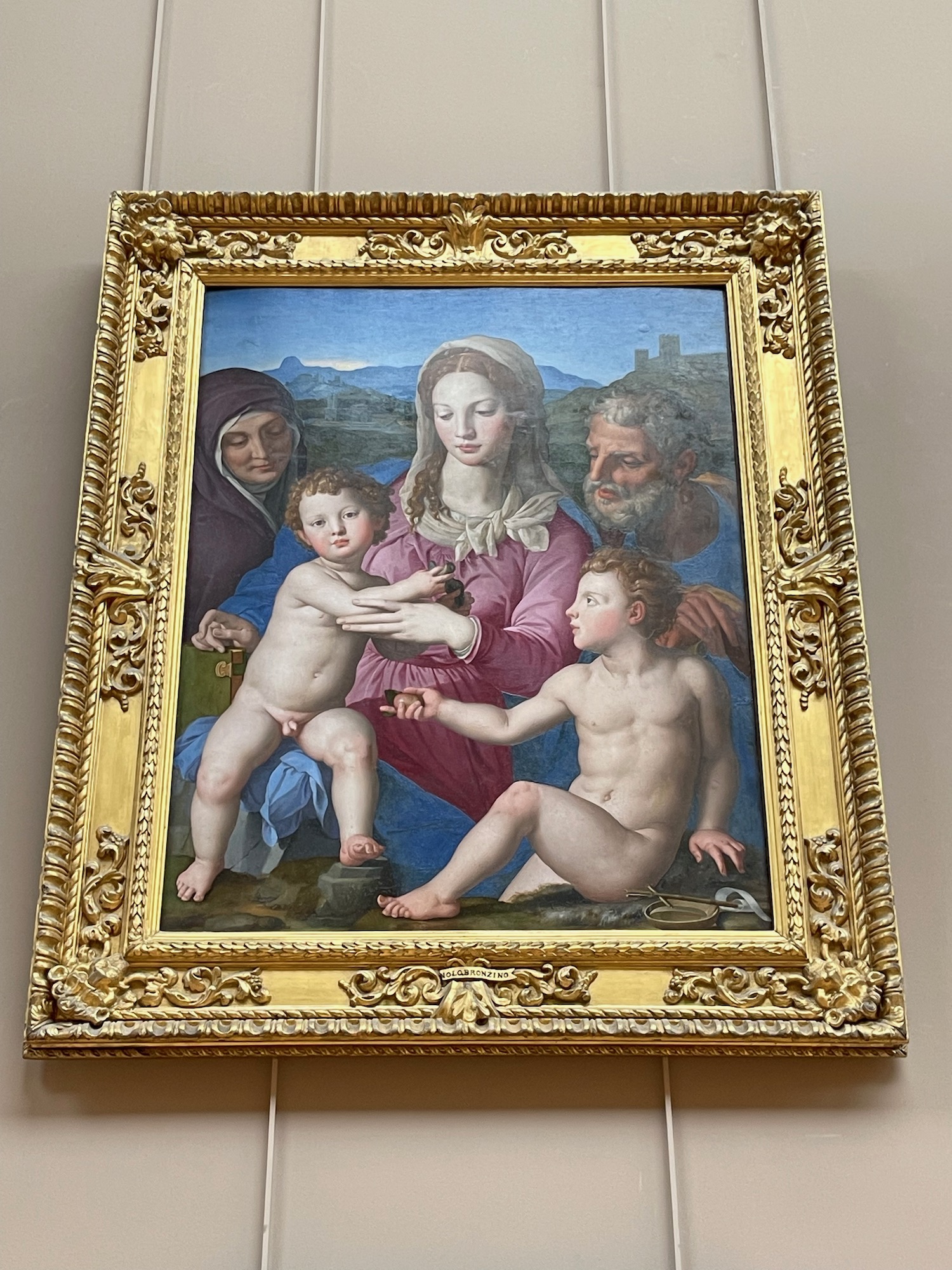 a painting of a woman holding a child and a man and a woman
