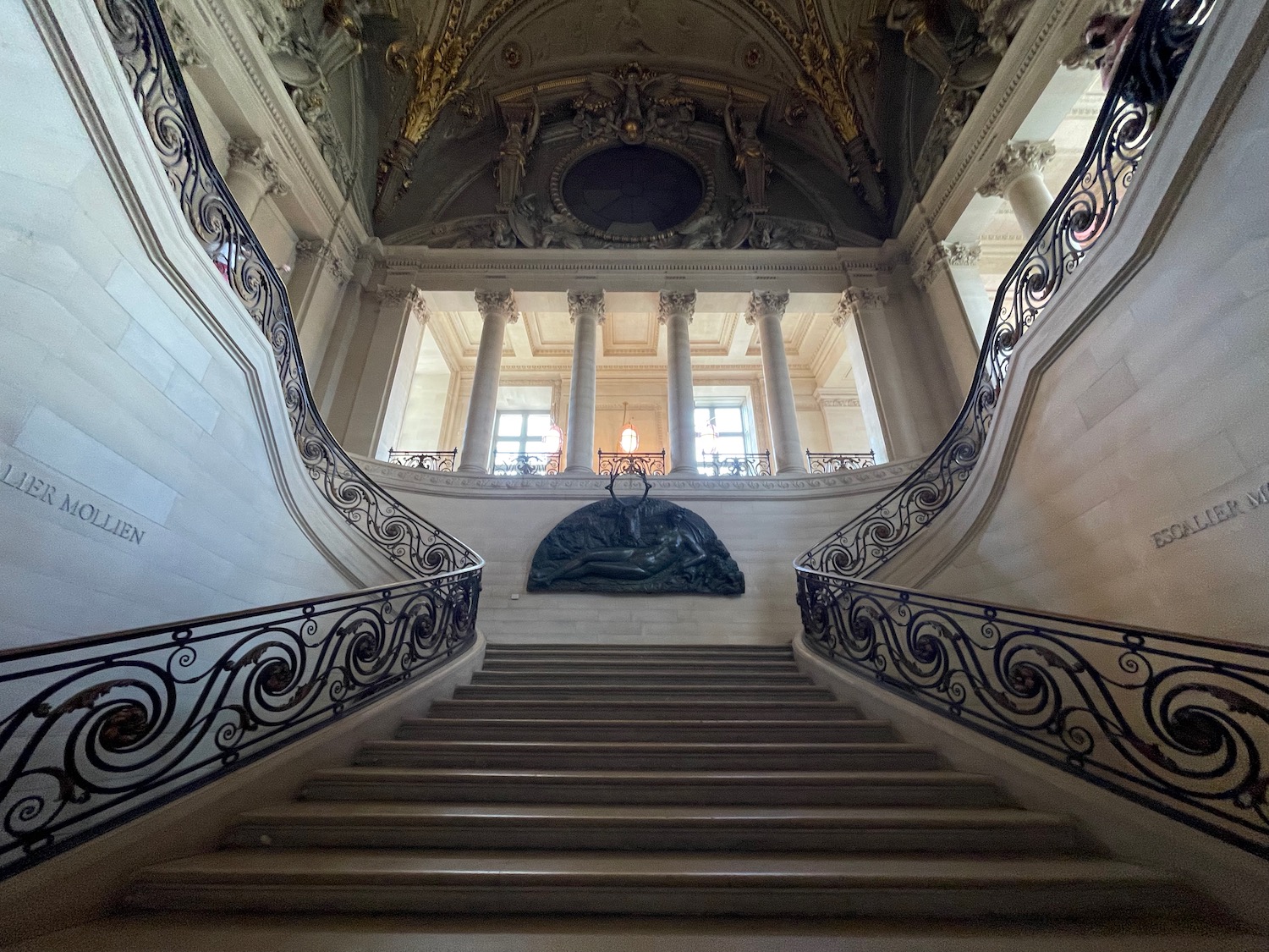 a staircase with a statue on top of it