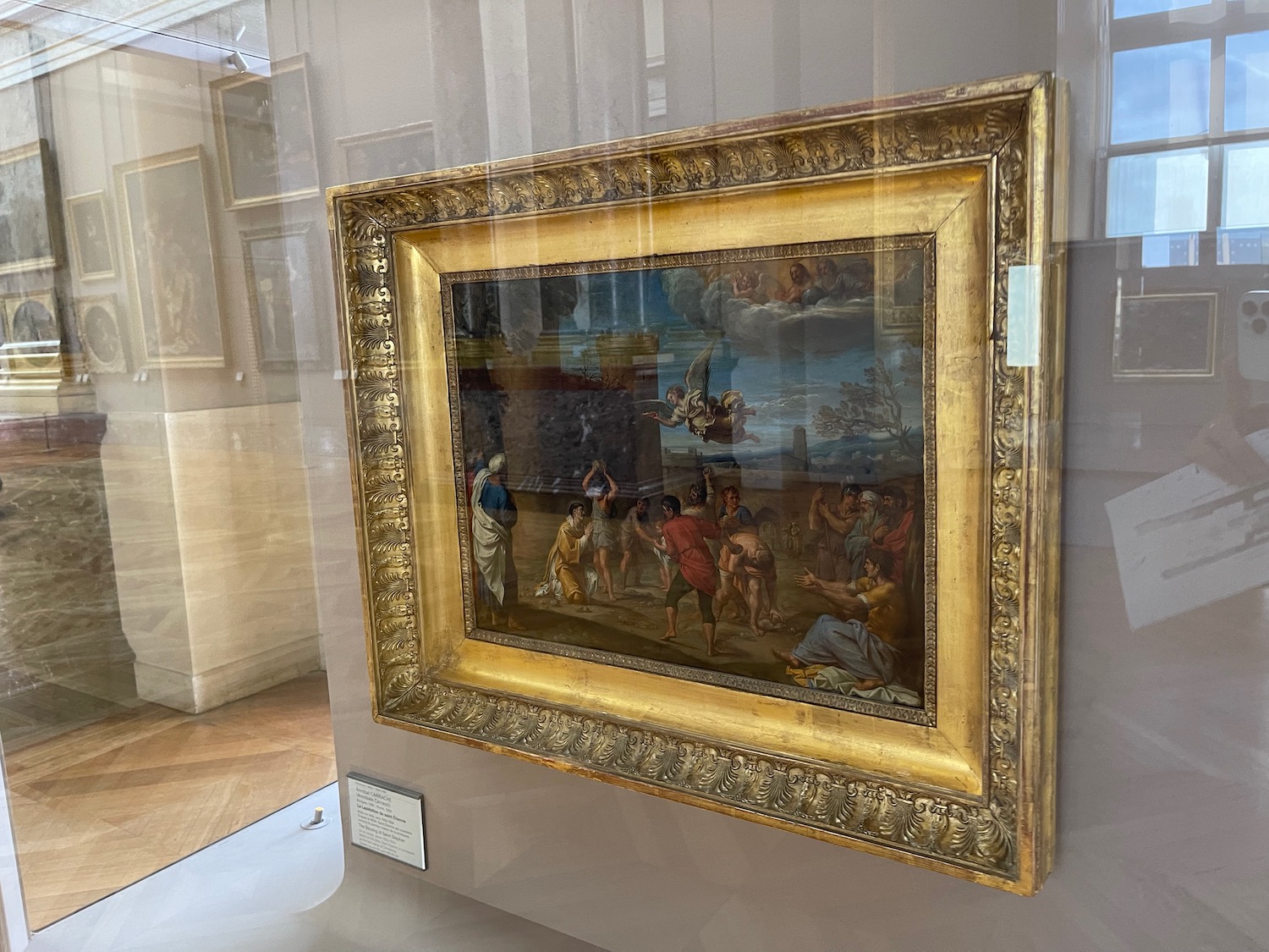a framed painting in a glass case