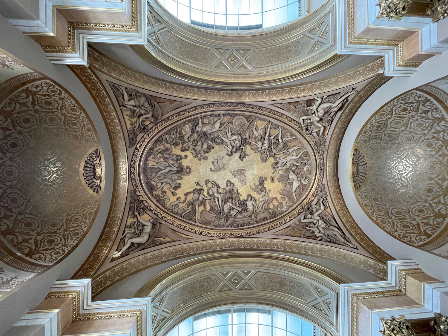 a ceiling with gold and white painted walls