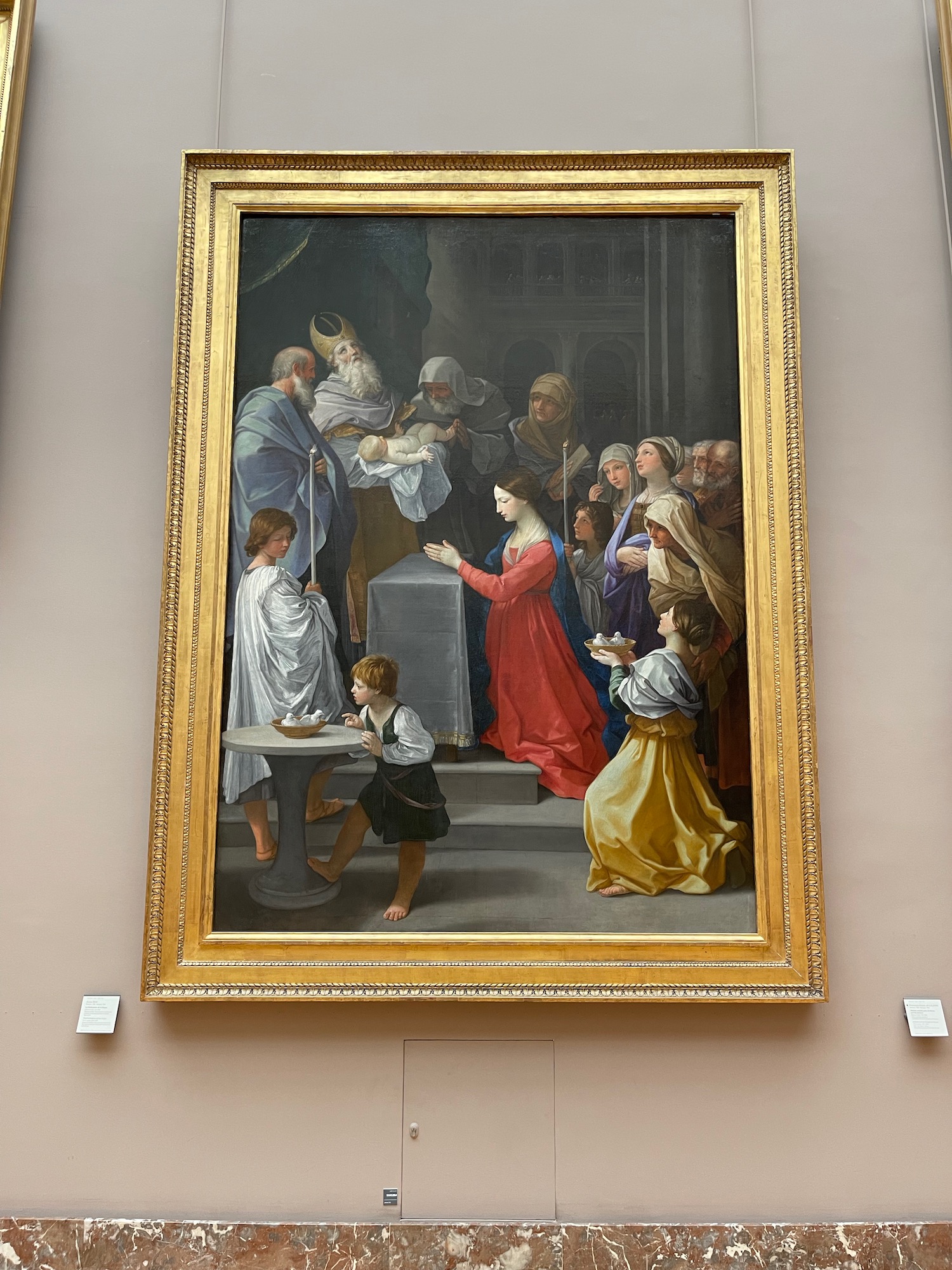 a painting of a group of people in a gold frame