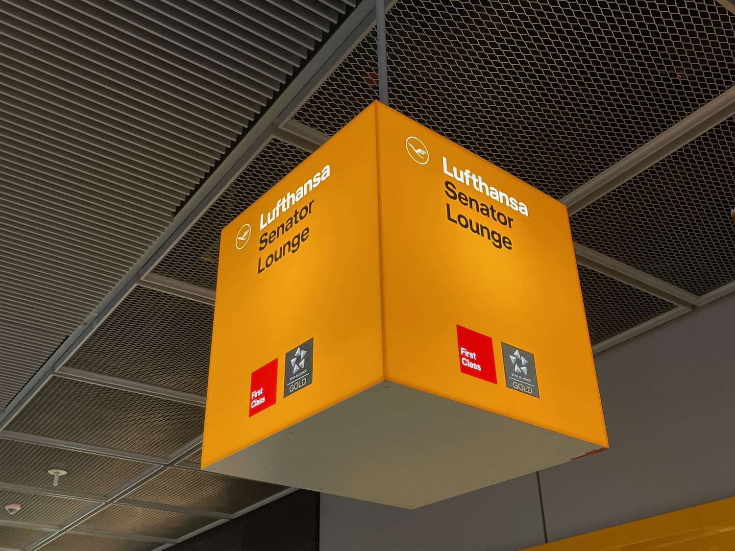 a yellow square sign from the ceiling