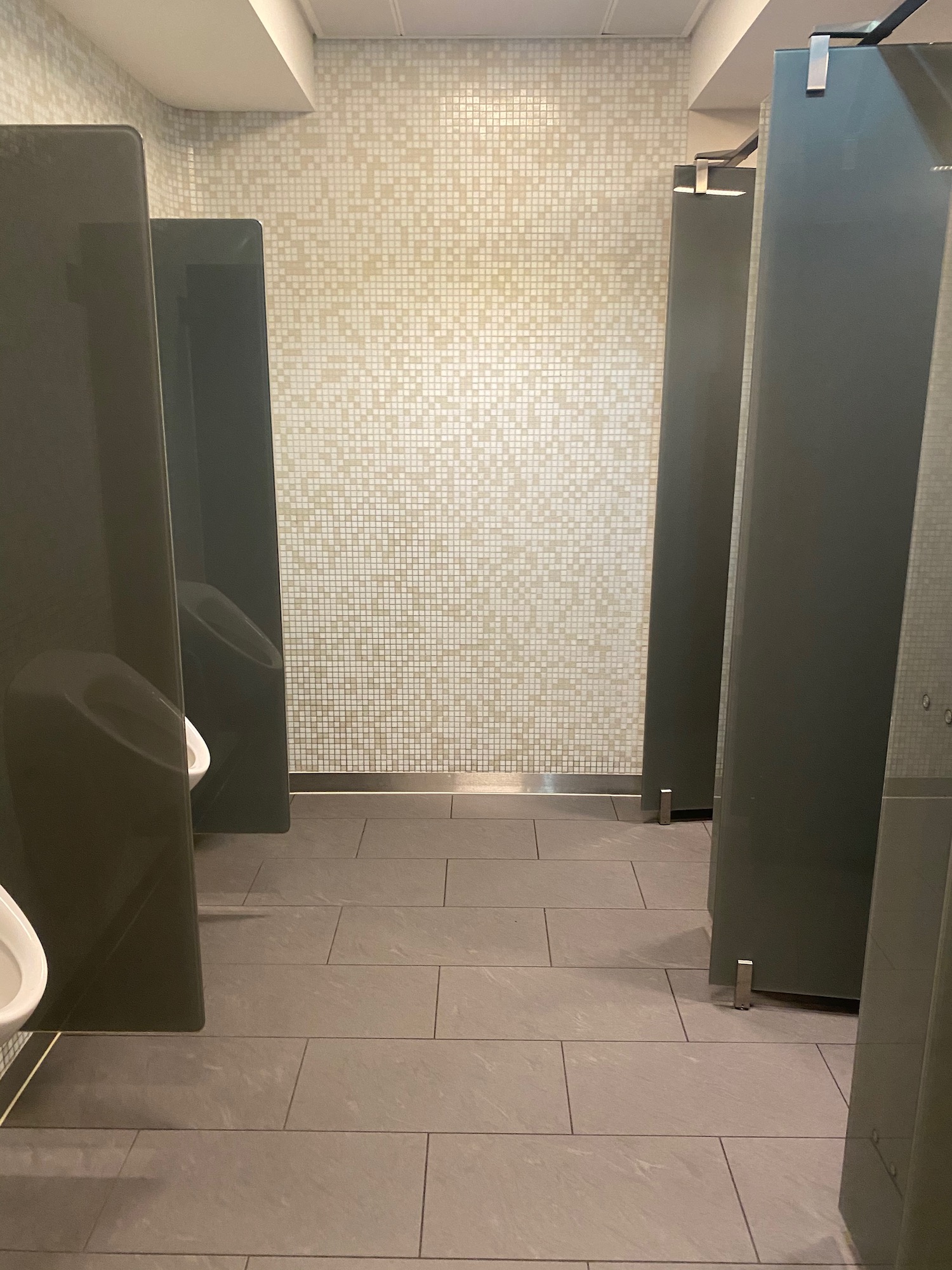 a bathroom with grey walls and a white tile floor