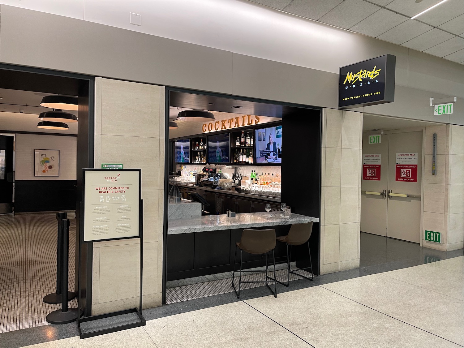 a bar with a counter and chairs in a building