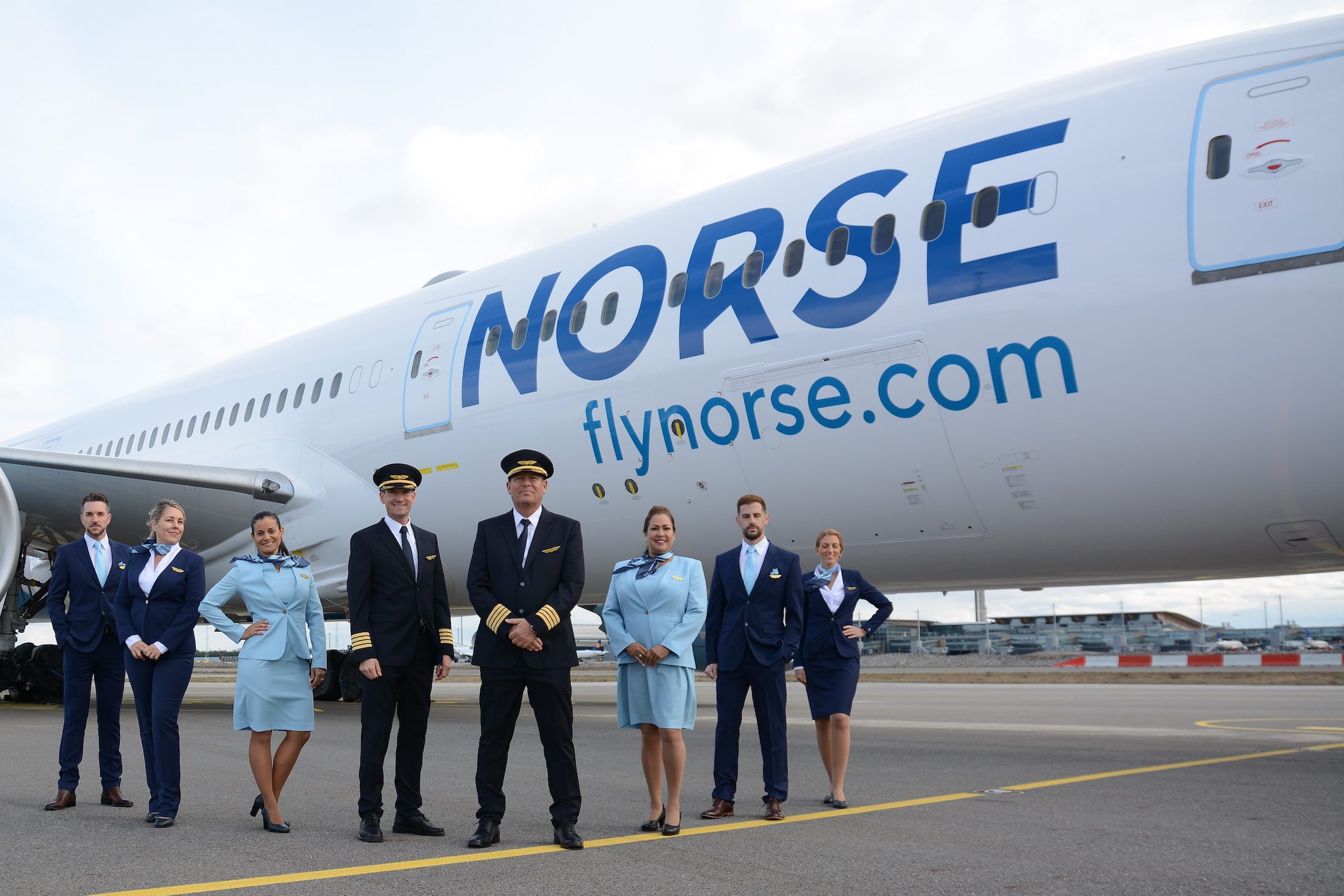 a group of people standing in front of a plane