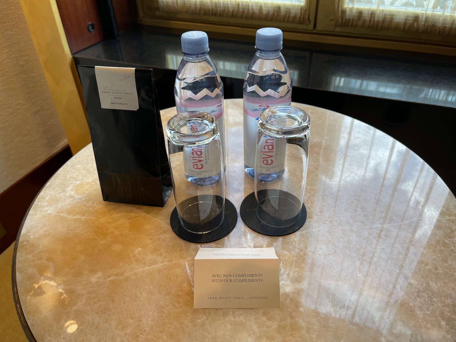 a group of water bottles and glasses on a table