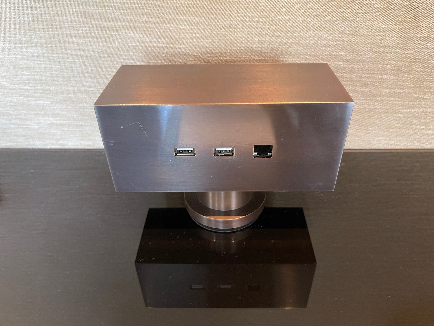 a metal box with usb ports on a black surface