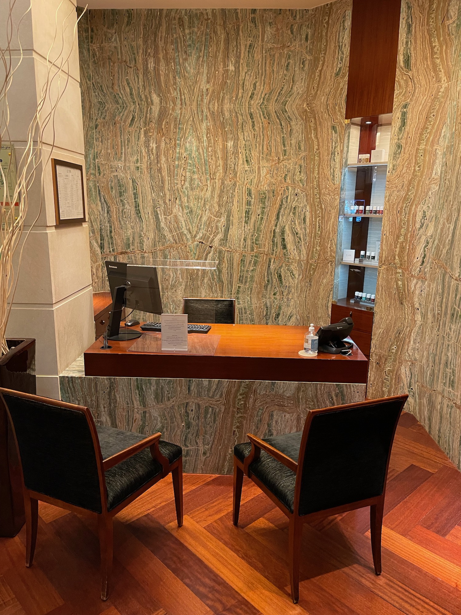 a desk with a computer and chairs in a room
