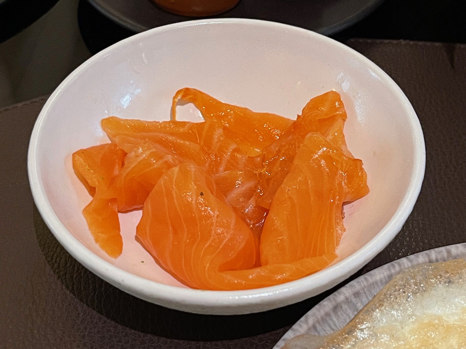 a bowl of raw salmon