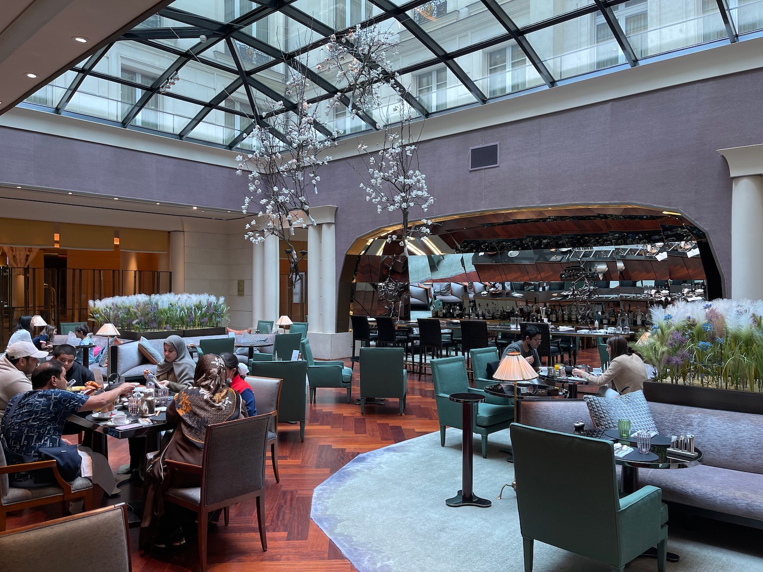 a group of people sitting at tables in a restaurant