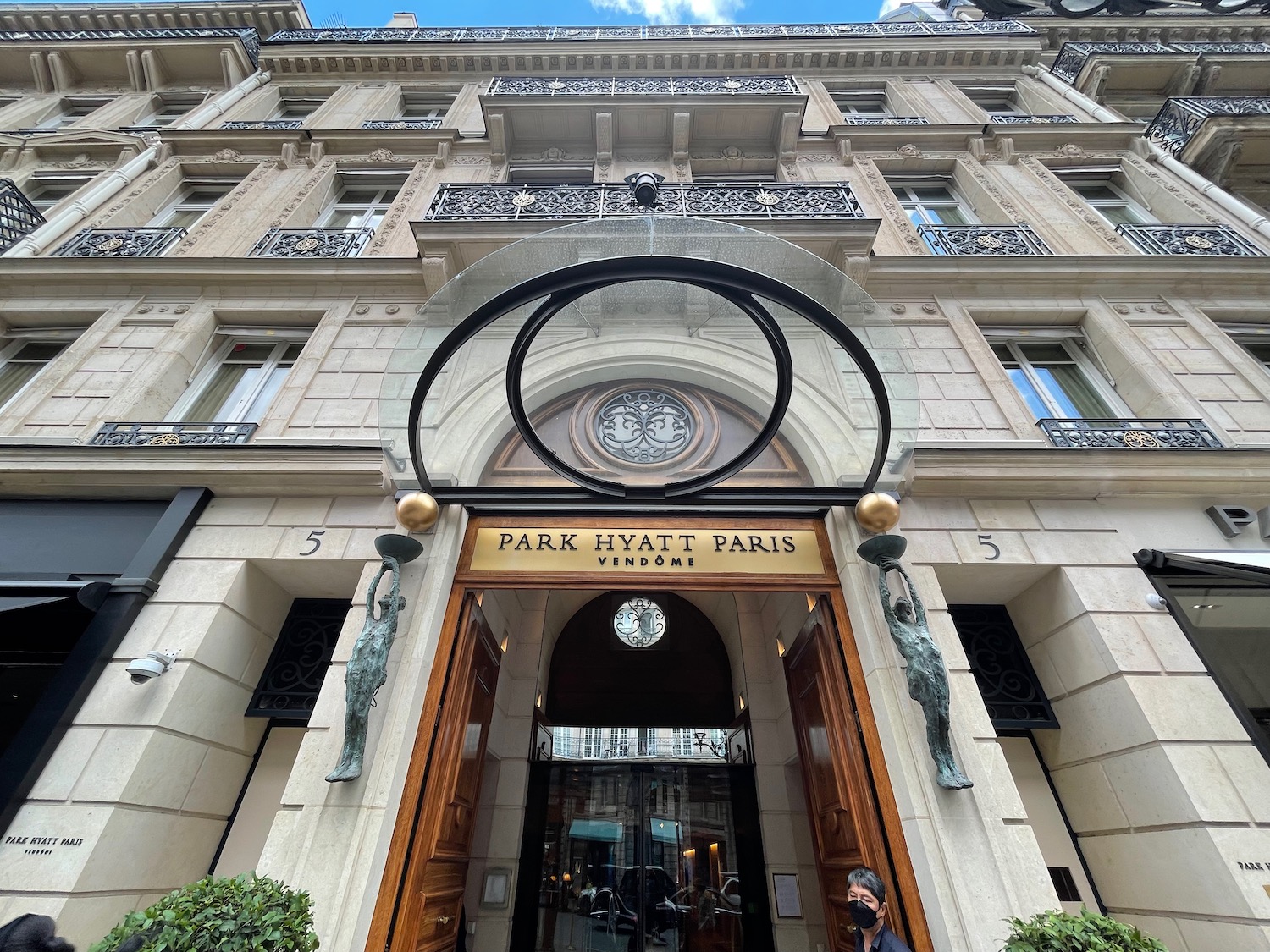 a building with a clock and a round glass door