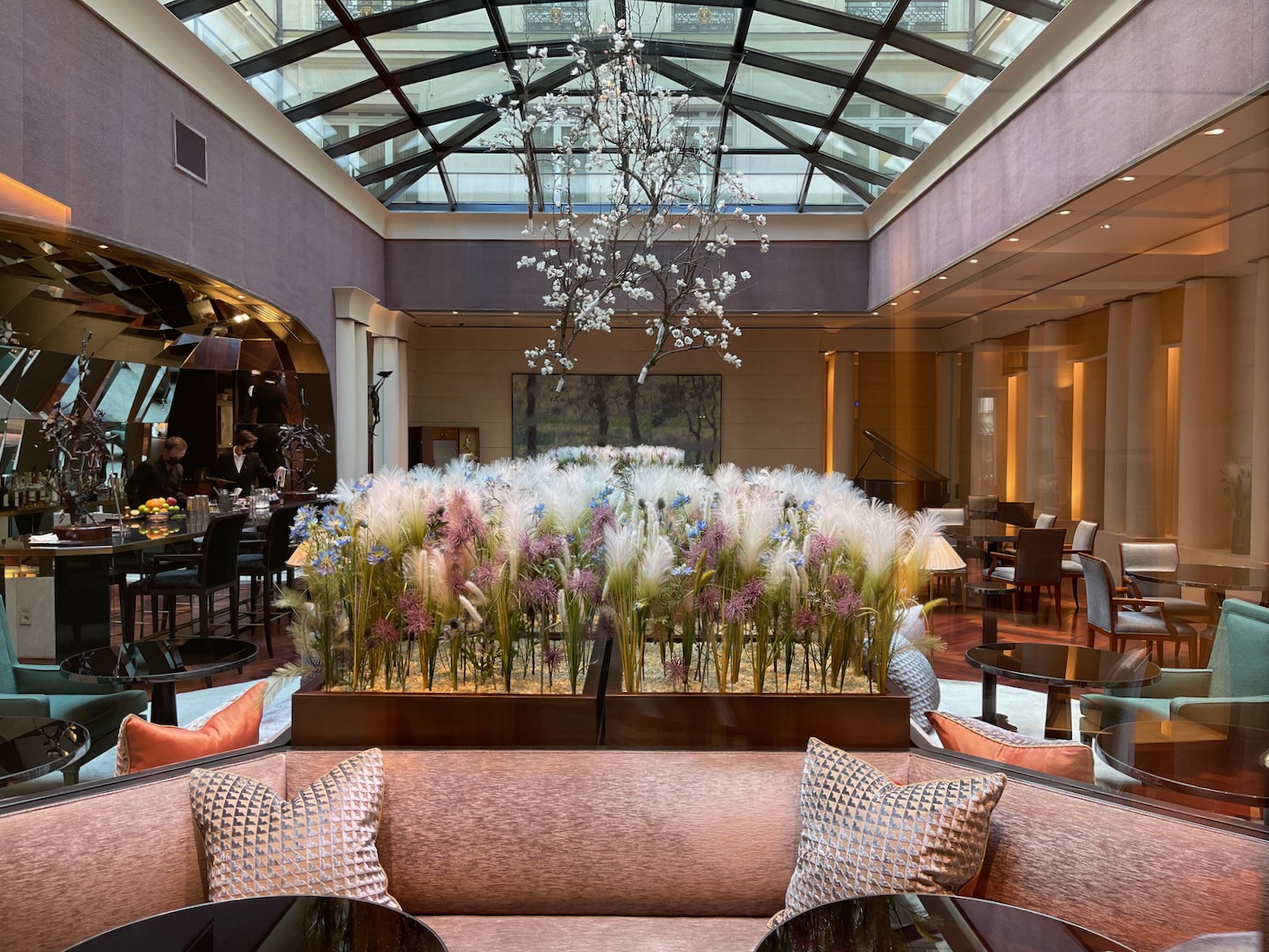 a room with a glass ceiling and a large flower display