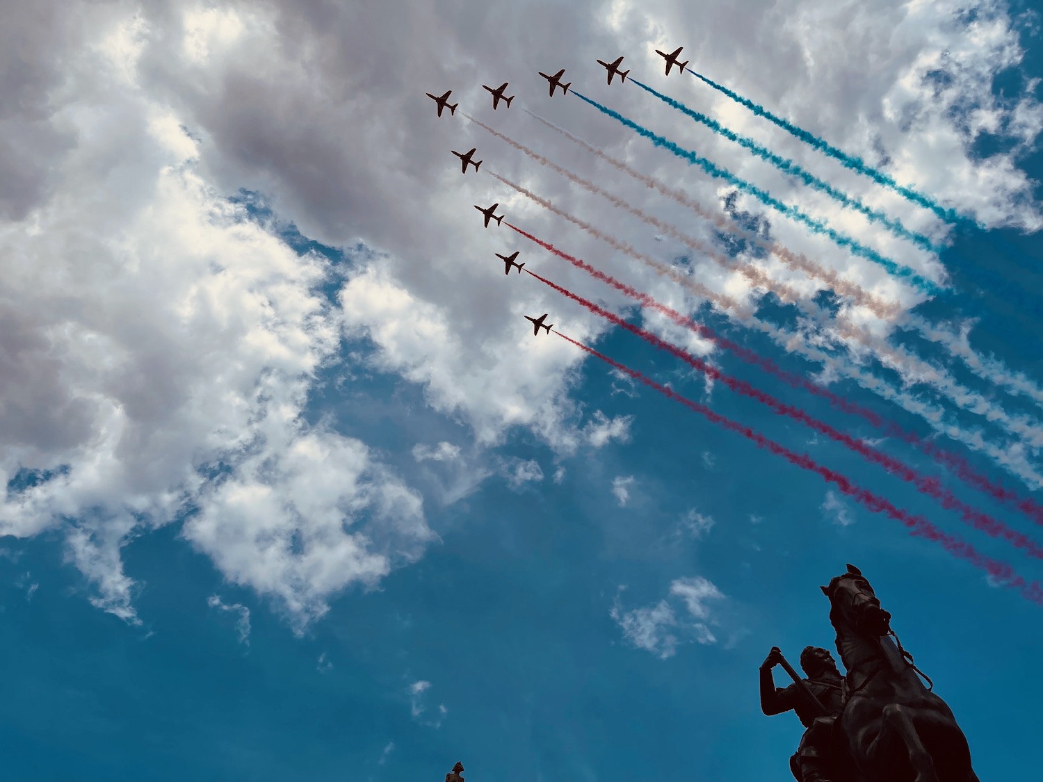 a group of airplanes flying in formation with smoke trails