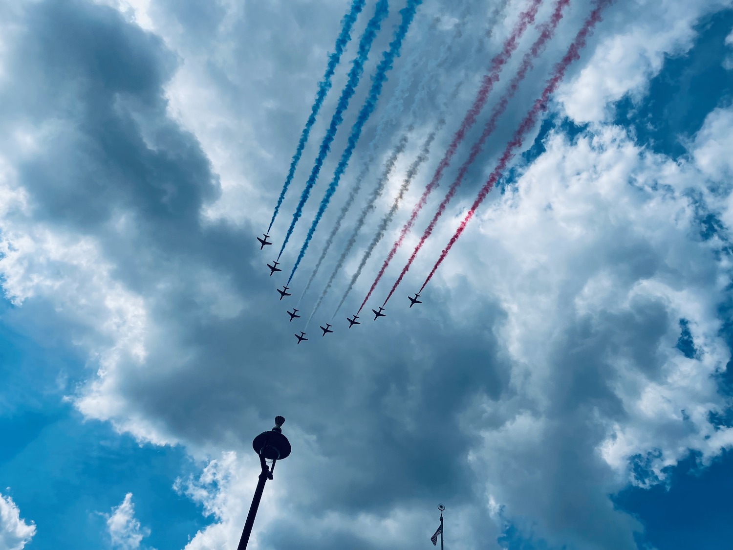 a group of airplanes flying in formation with smoke trails