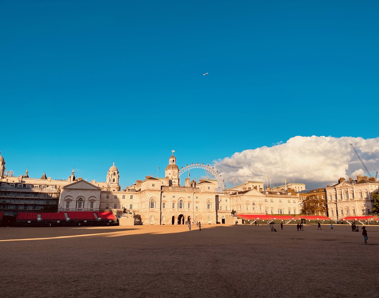 a large square with buildings and a ferris wheel