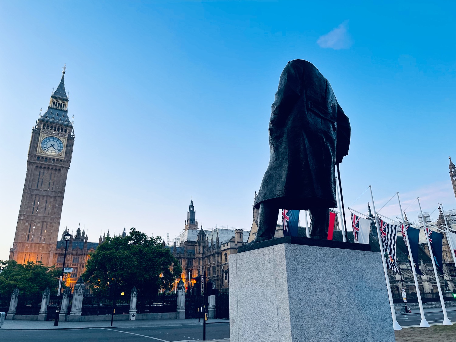 a statue of a man in front of a clock tower