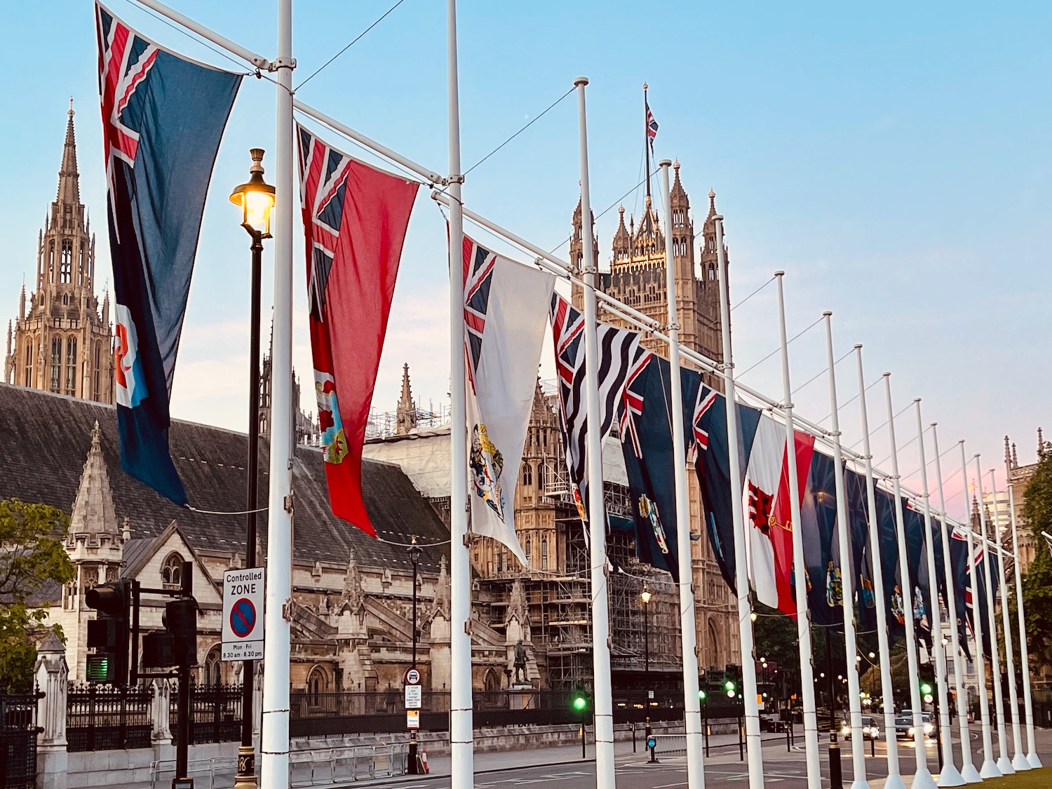 a row of flags on poles