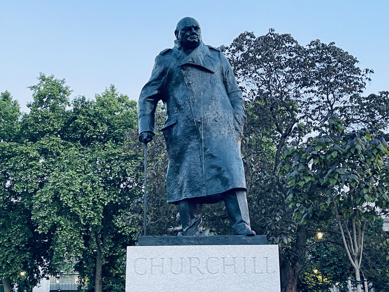 a statue of a man in a trench coat