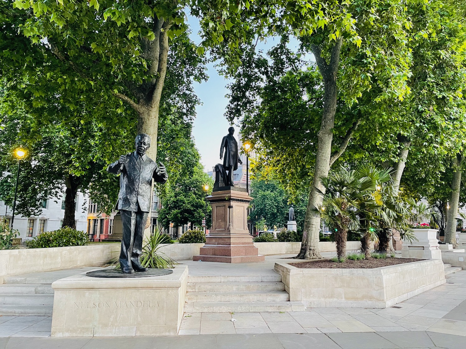 a statue of a man and a man in a park