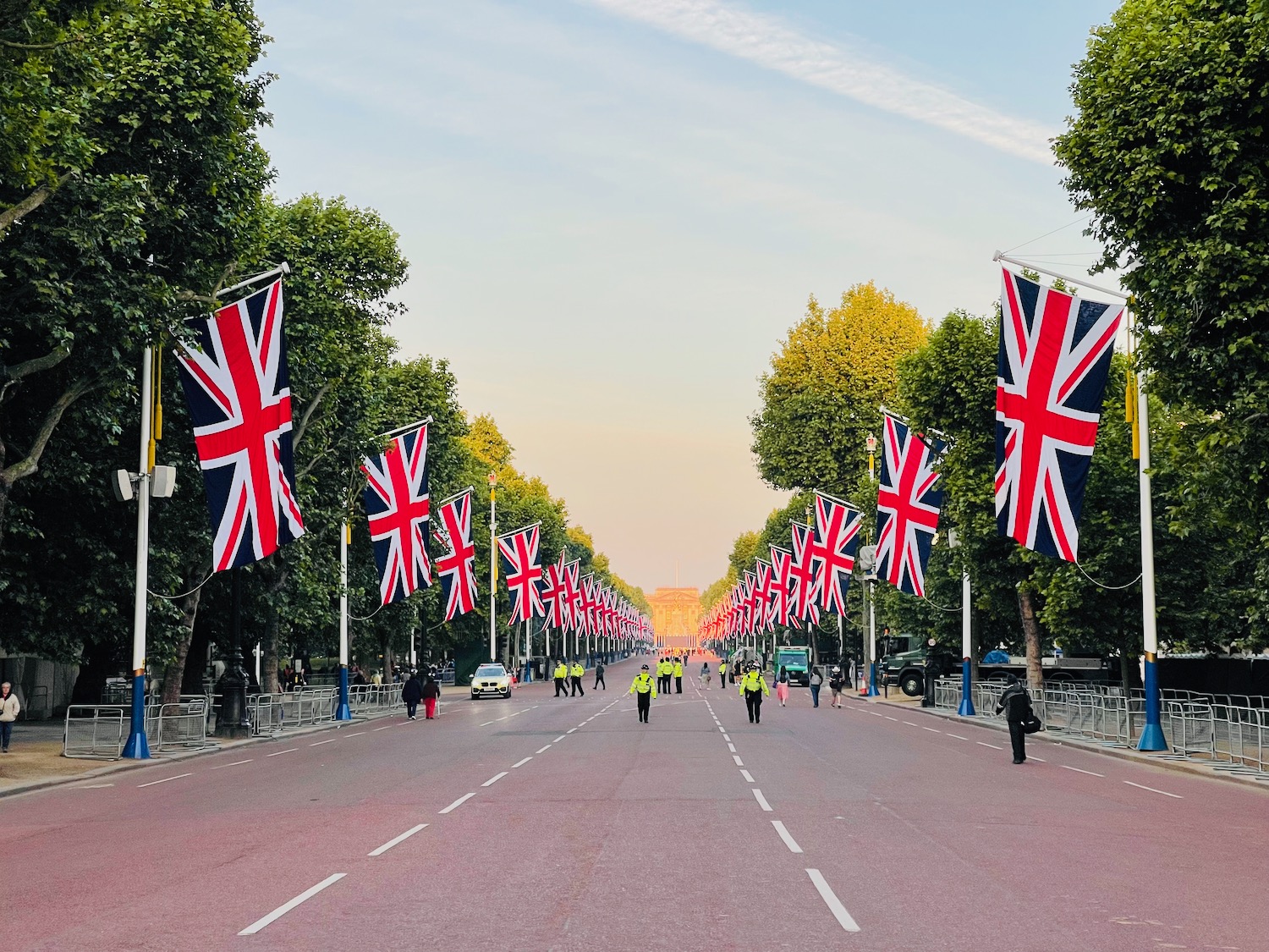 a street with flags on it with The Mall, London in the background