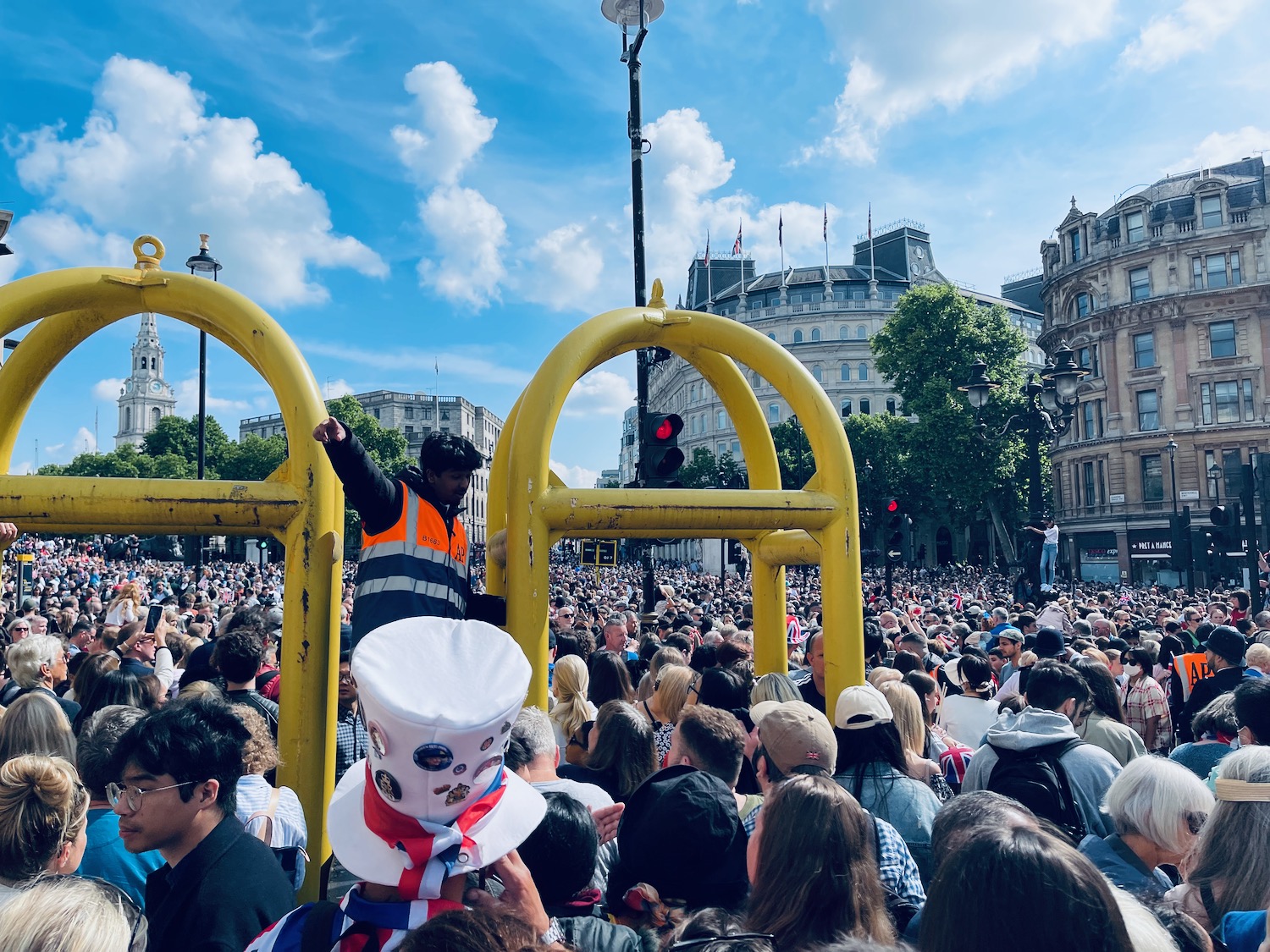 a man standing on a yellow structure in front of a crowd of people