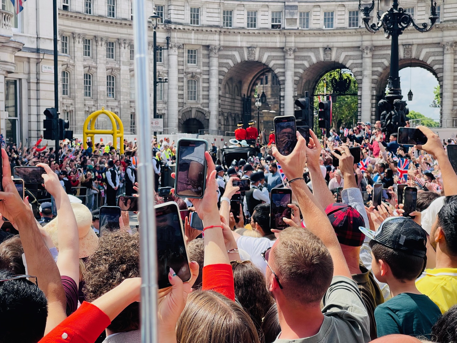 a group of people holding phones in front of a crowd