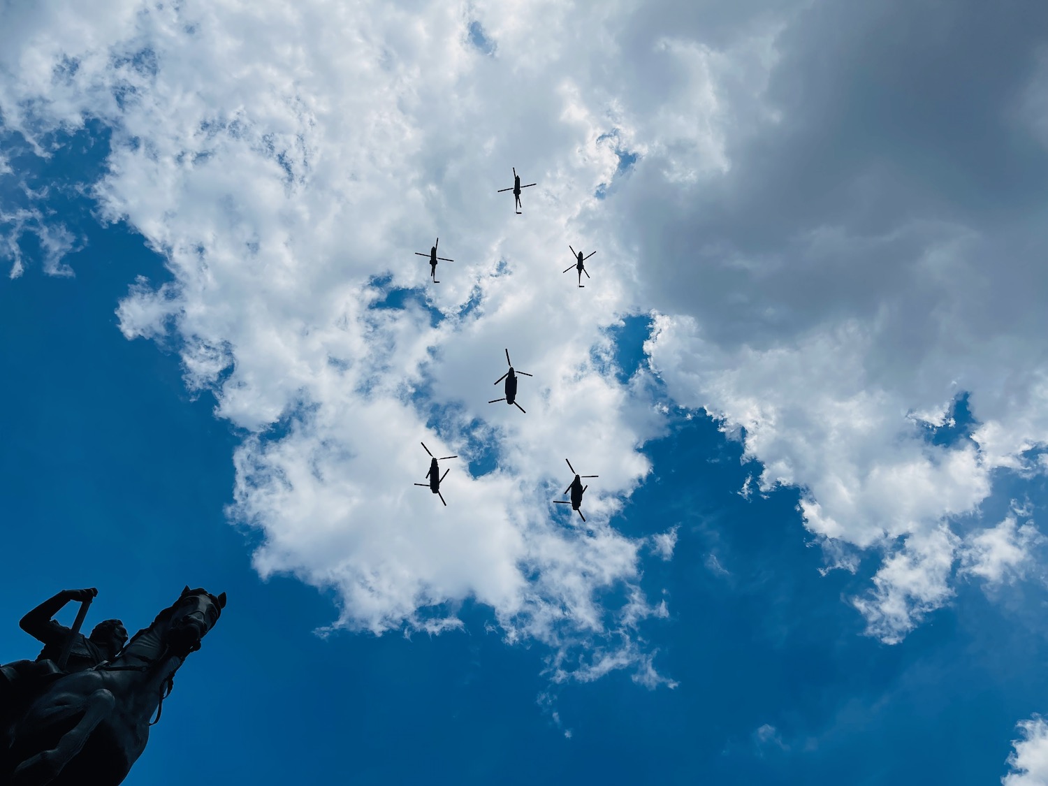 a group of helicopters flying in the sky