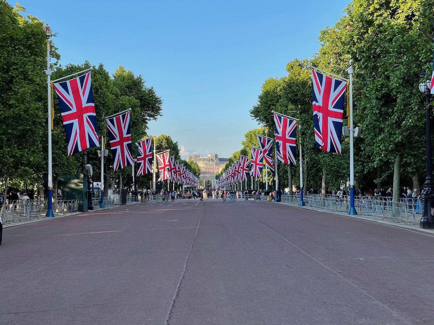 a street with flags on it with The Mall, London in the background