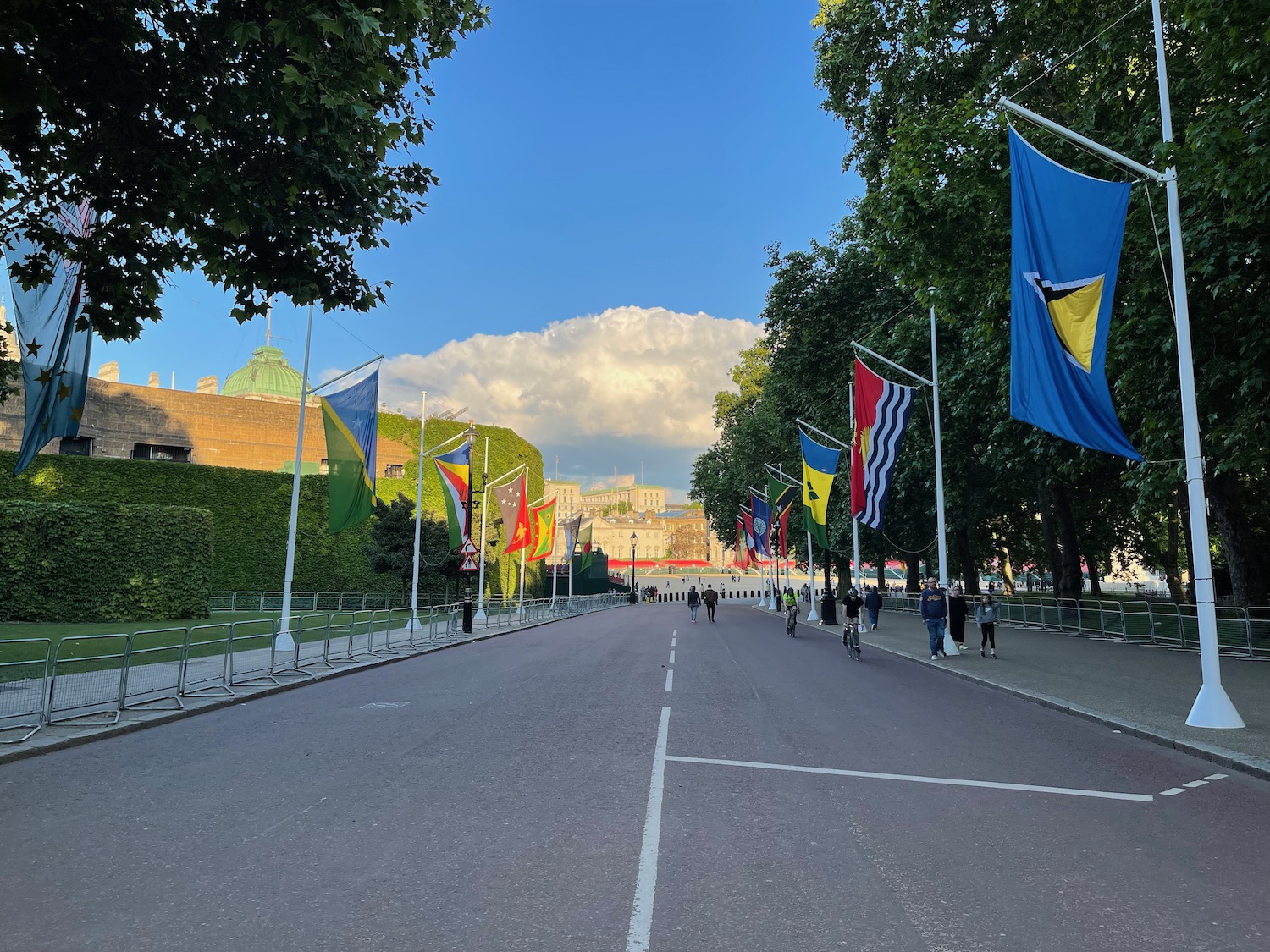 a street with flags and people walking on it