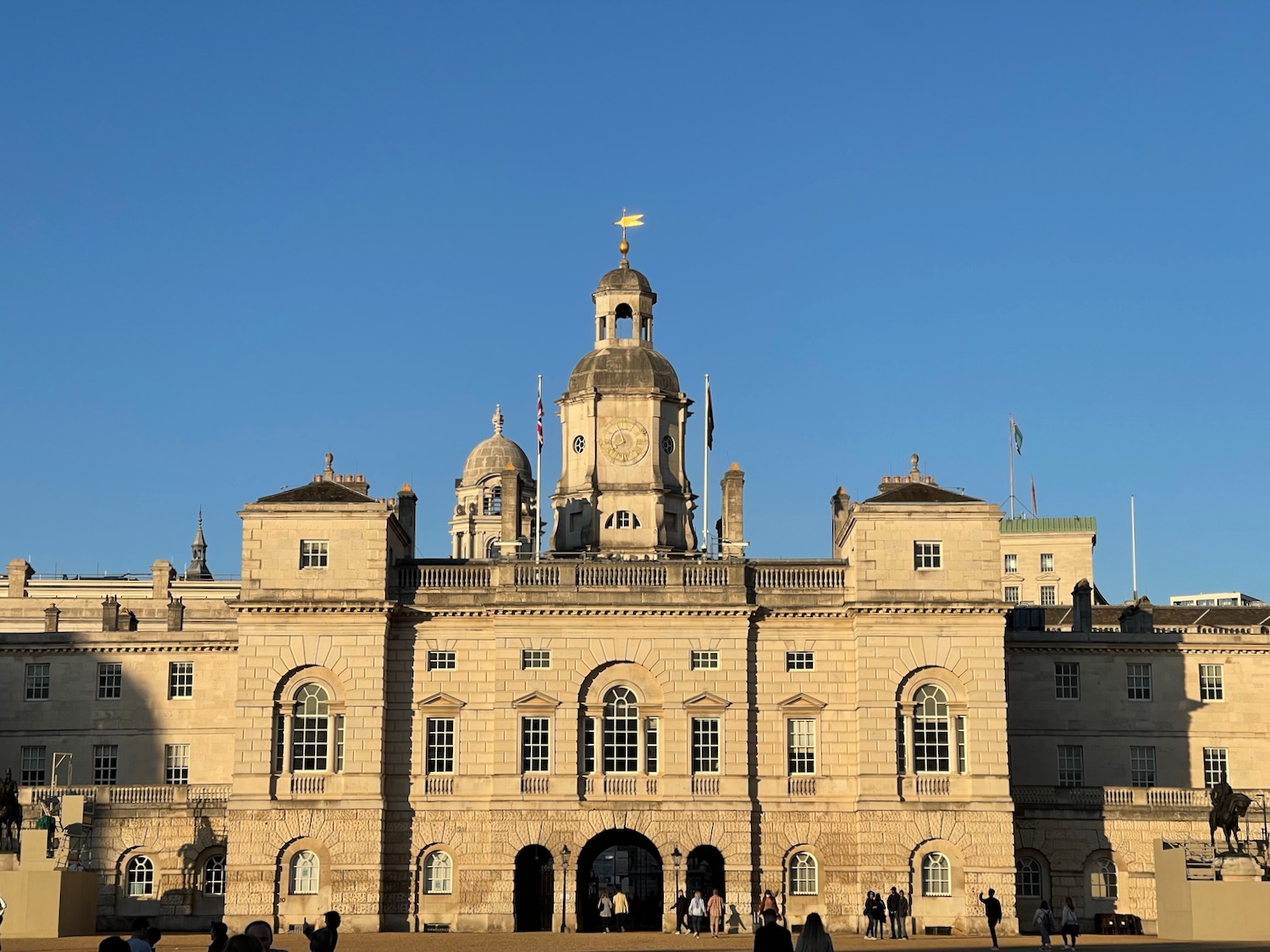 a large stone building with a dome and a flag on top