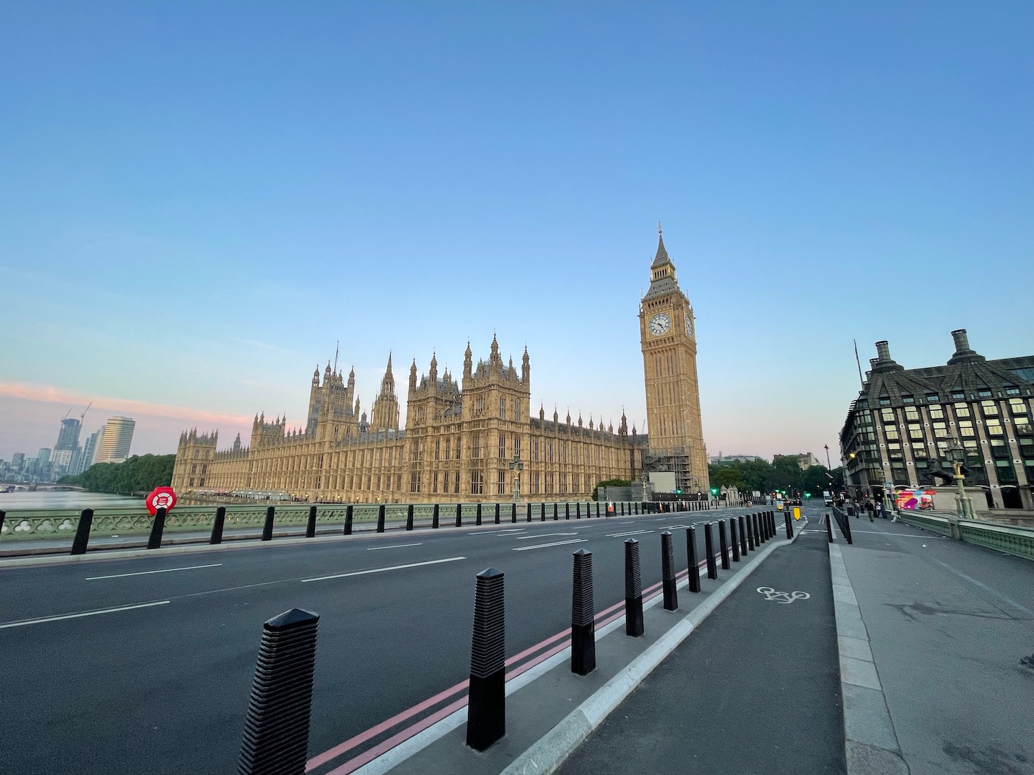 a large building with a clock tower and a road