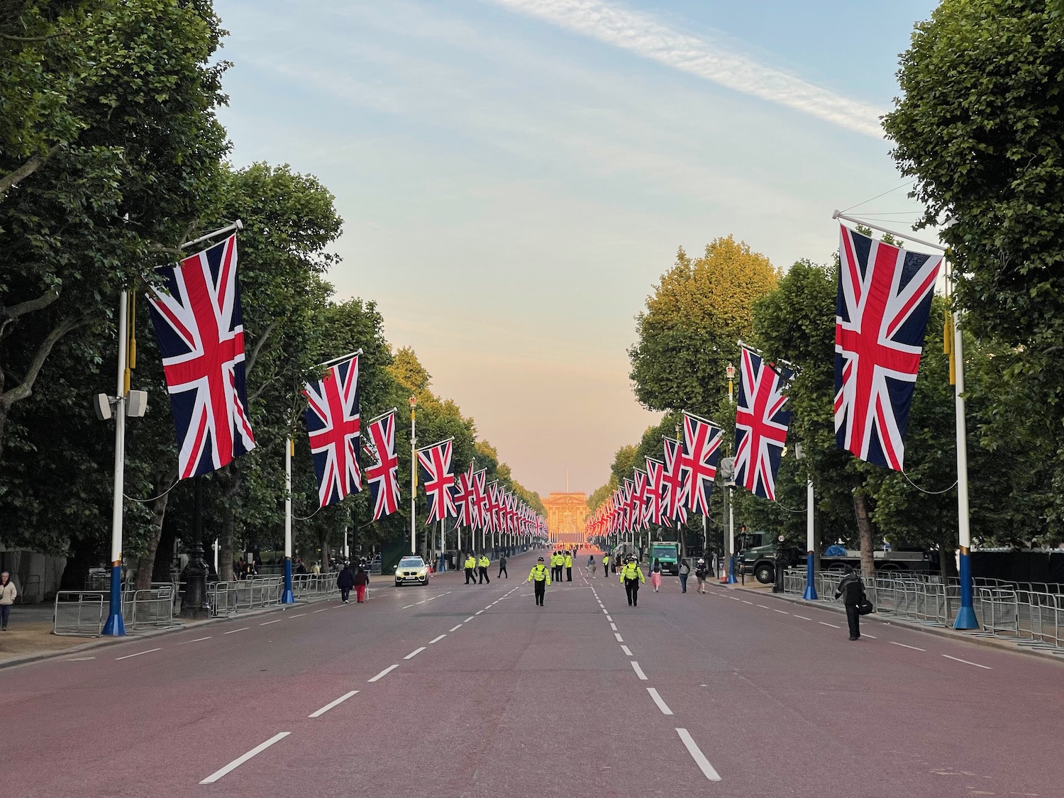 a street with flags on it with The Mall, London in the background