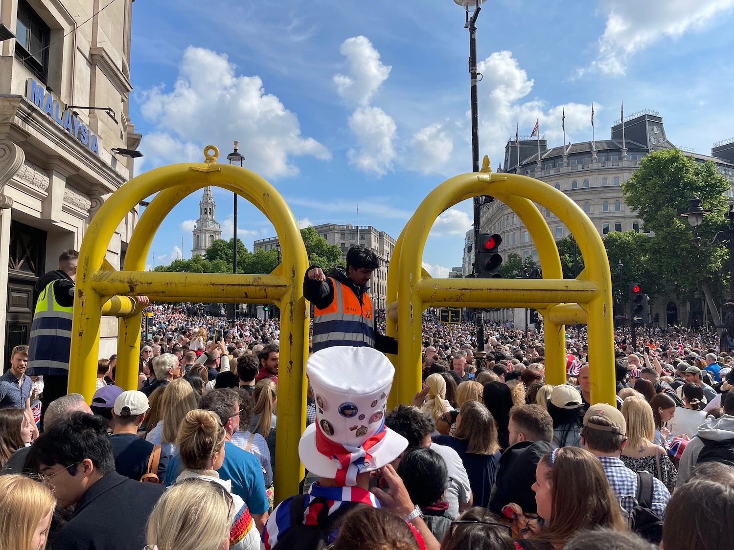 a man in a garment standing in a crowd of people