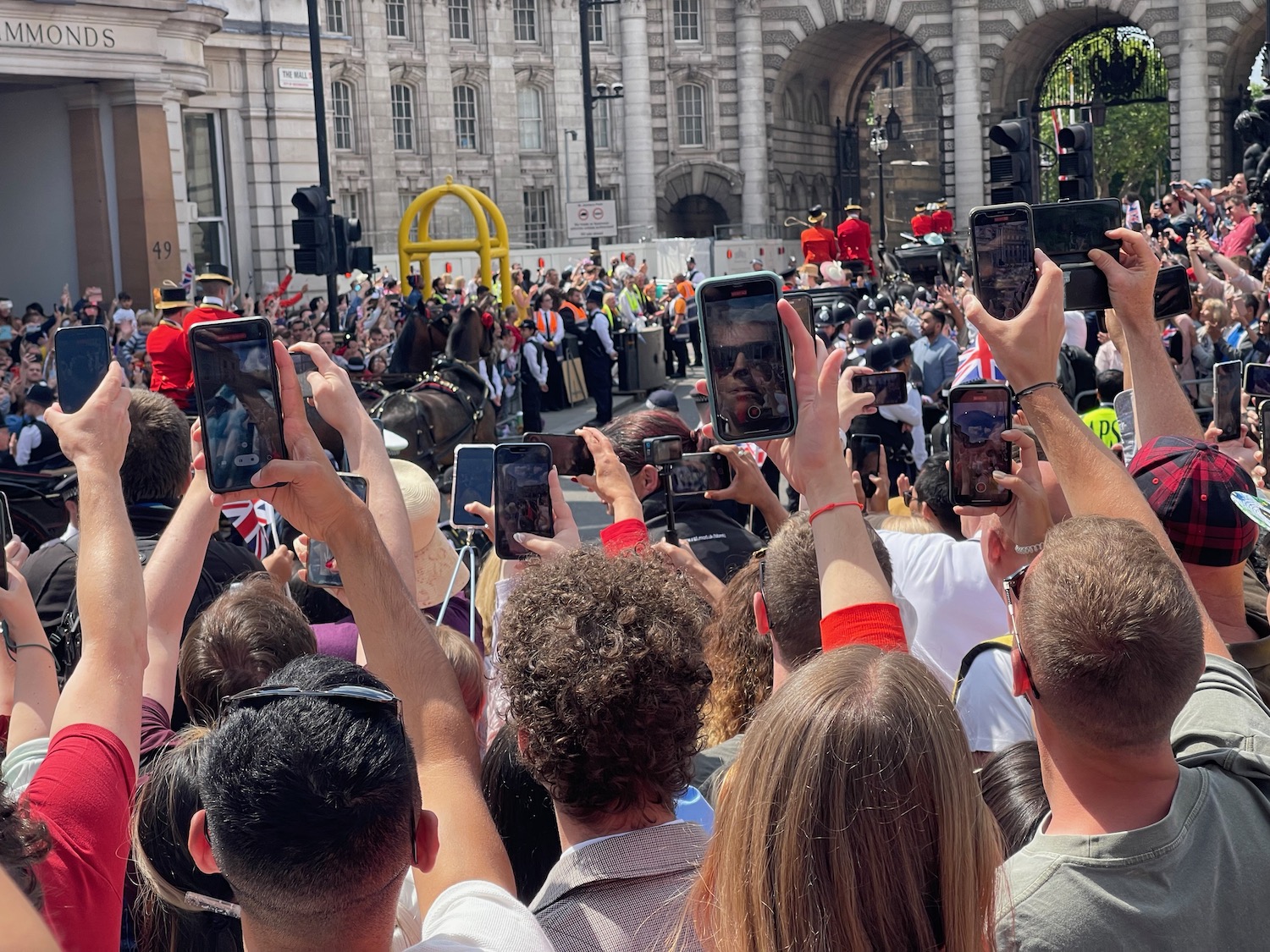 a group of people taking pictures of a parade