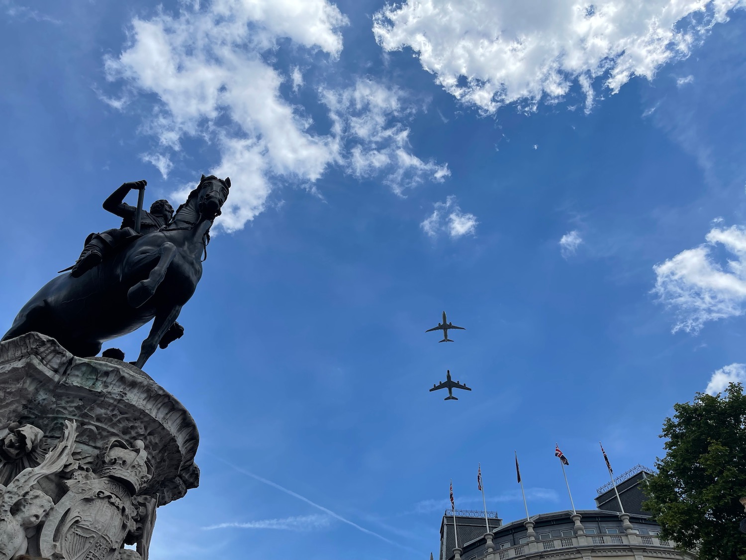 a statue of a man on a horse and two planes flying in the sky