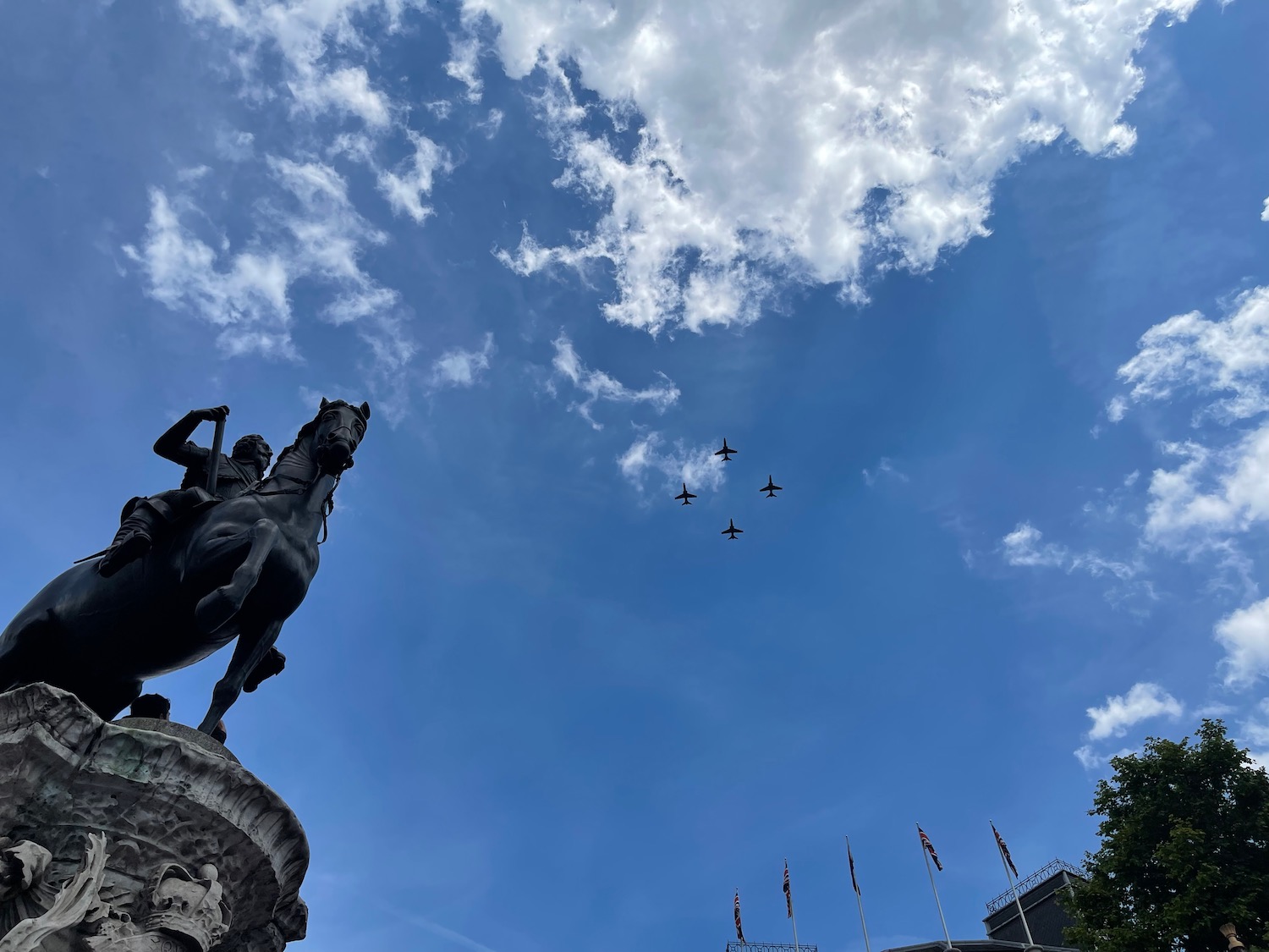 a statue of a man on a horse with a group of jets flying in the sky