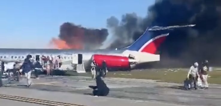 a plane on the runway with smoke coming out of it