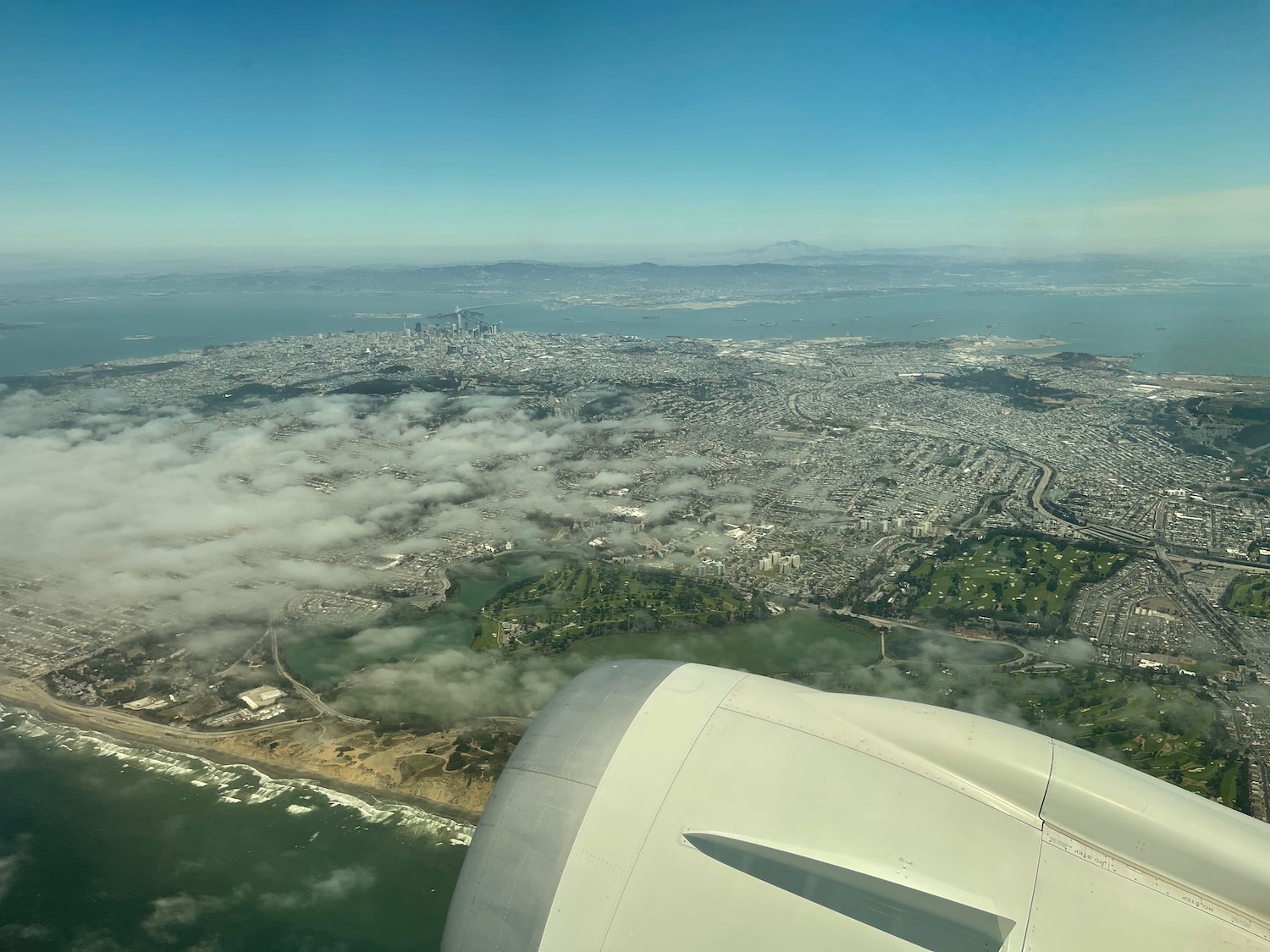 an airplane wing over a city