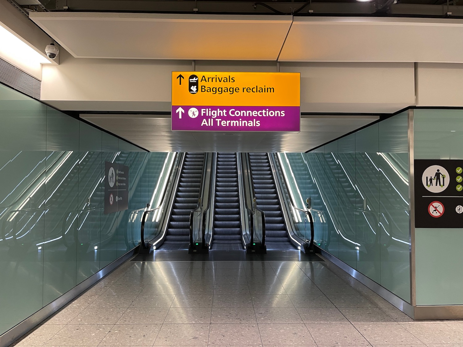 an escalator with an airport sign