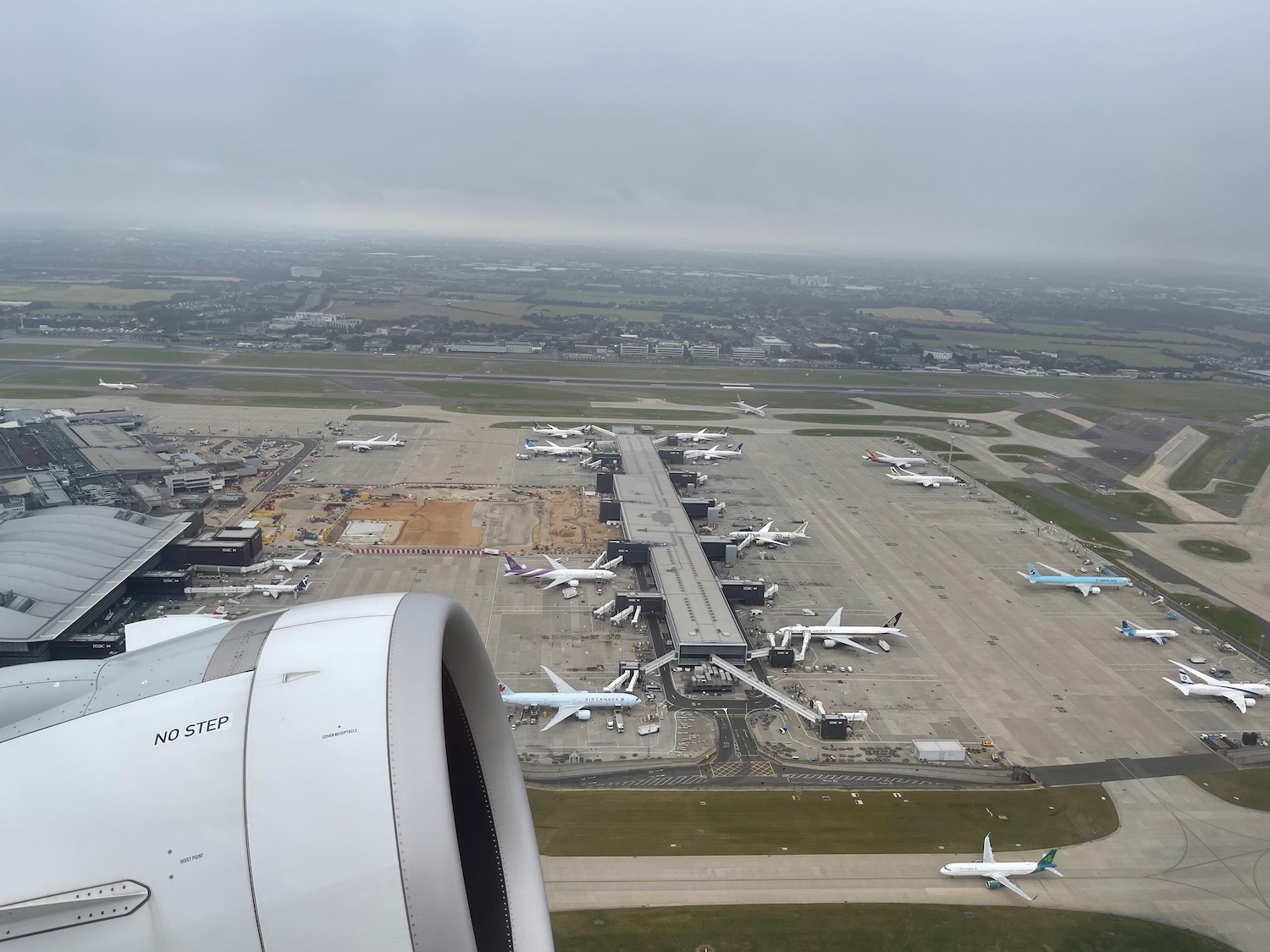 an aerial view of an airport with many airplanes