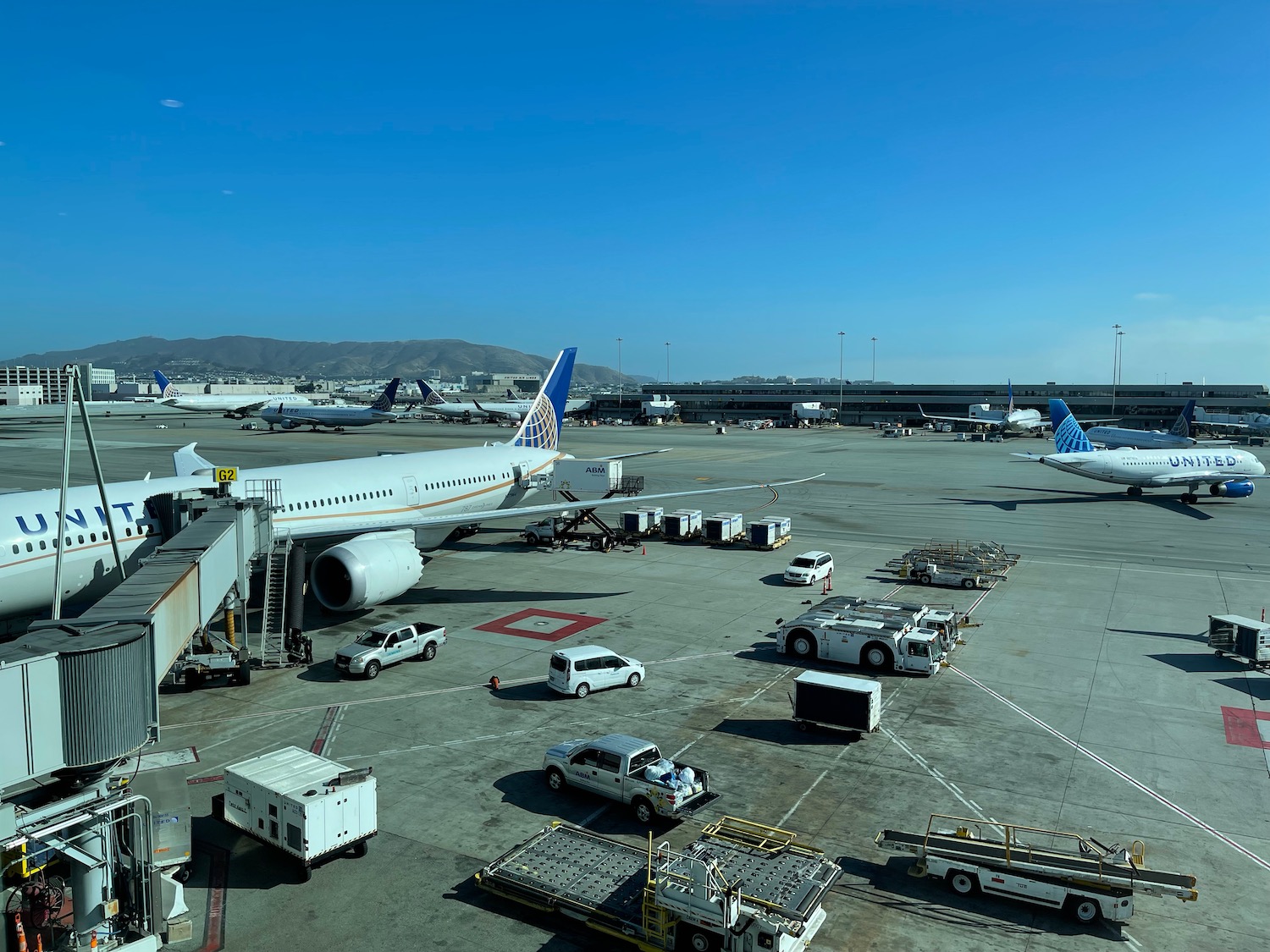 an airport with airplanes and trucks