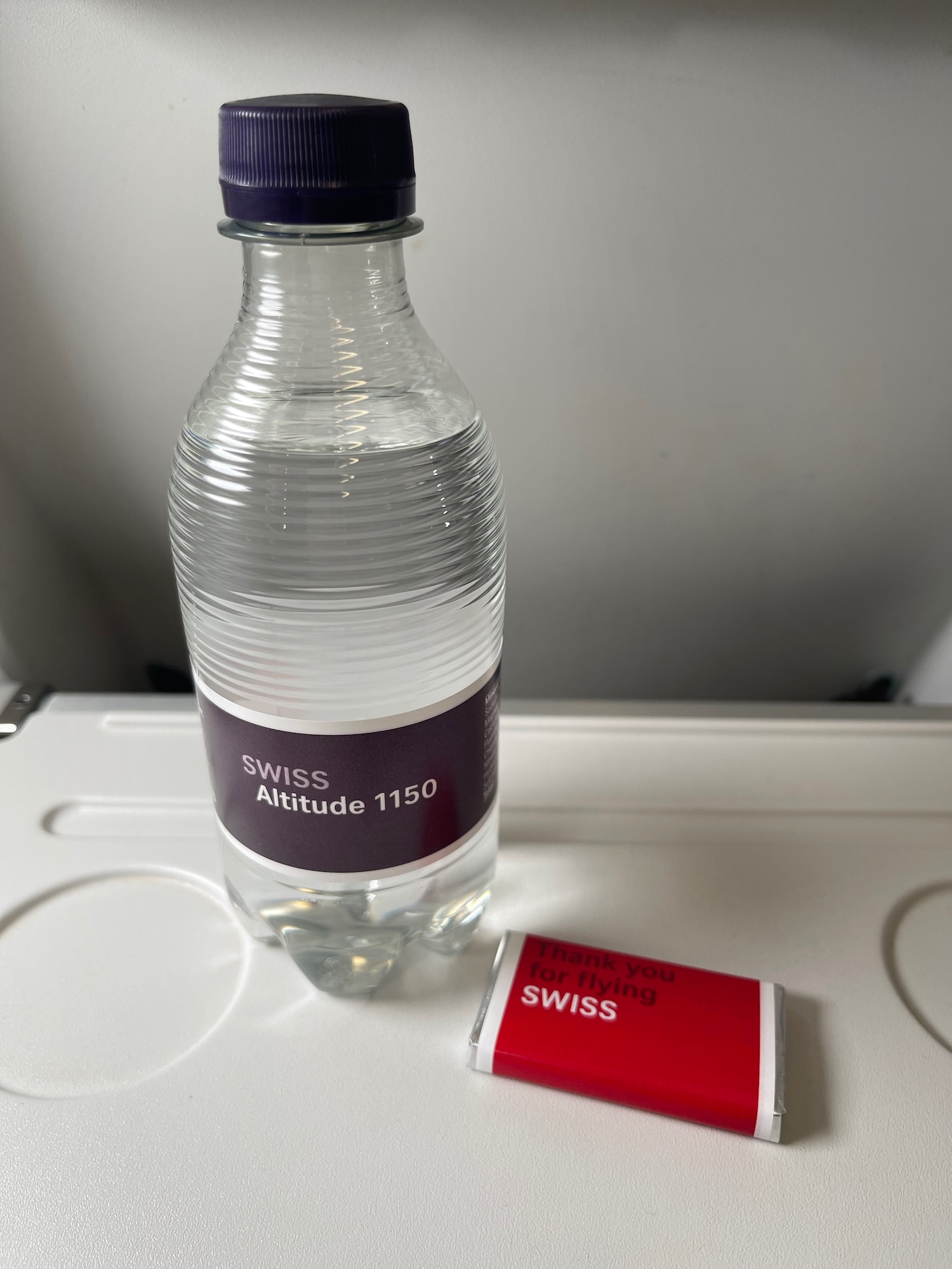a bottle of water and a small red packet