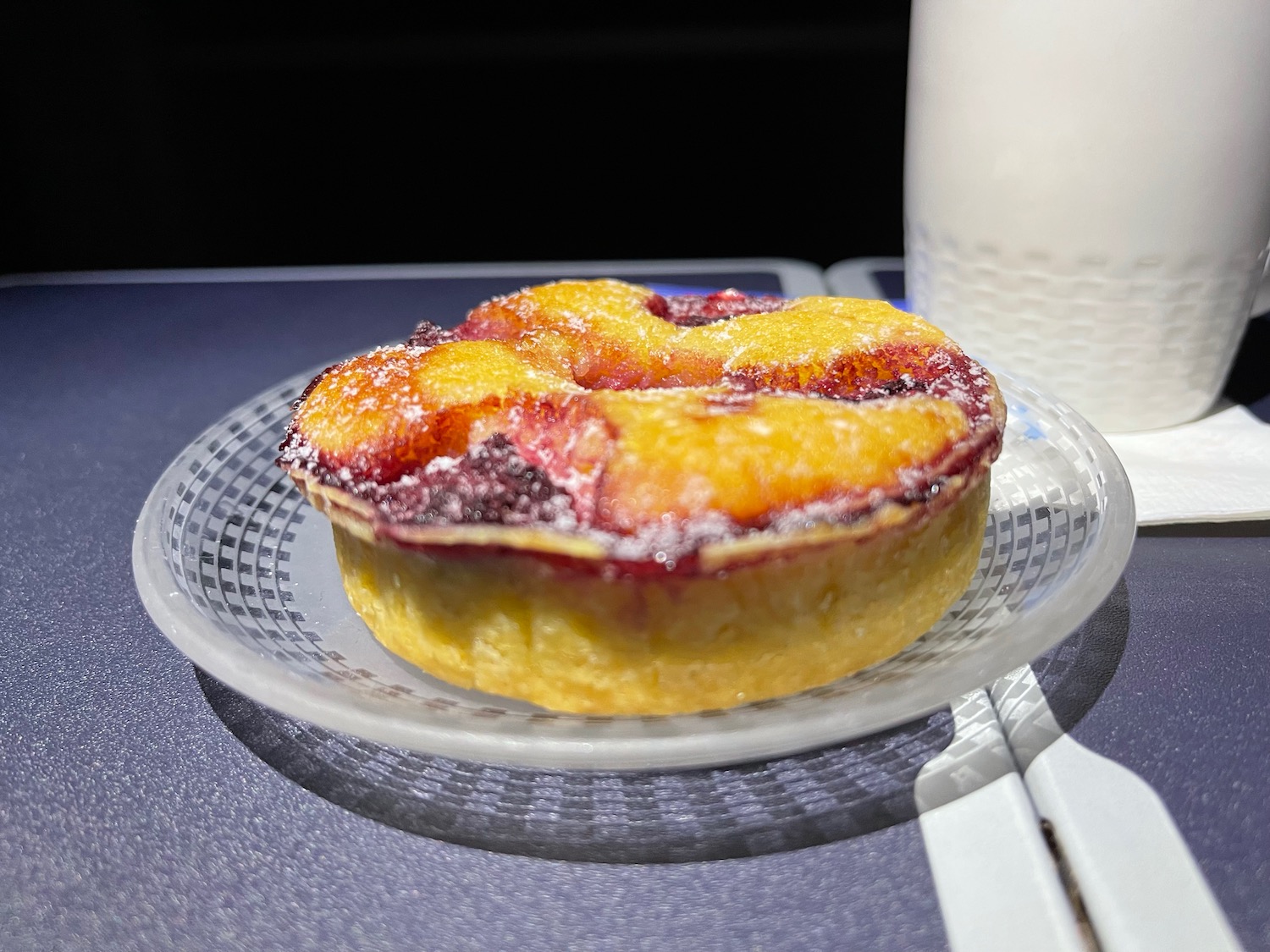 a small round pastry on a clear plate