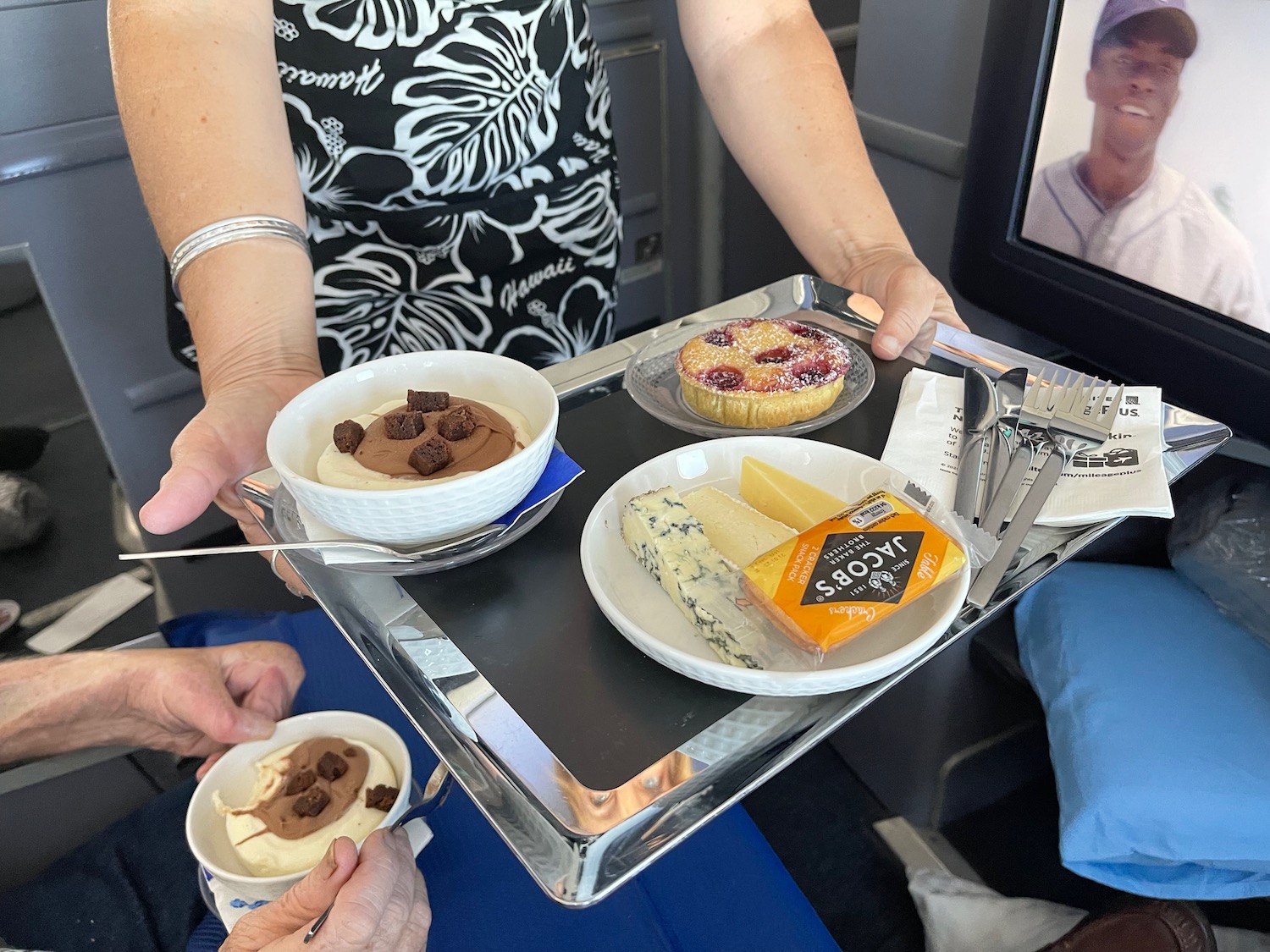 a person holding a tray of food