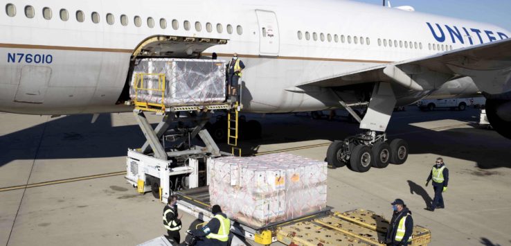 a large airplane with luggage being loaded with luggage