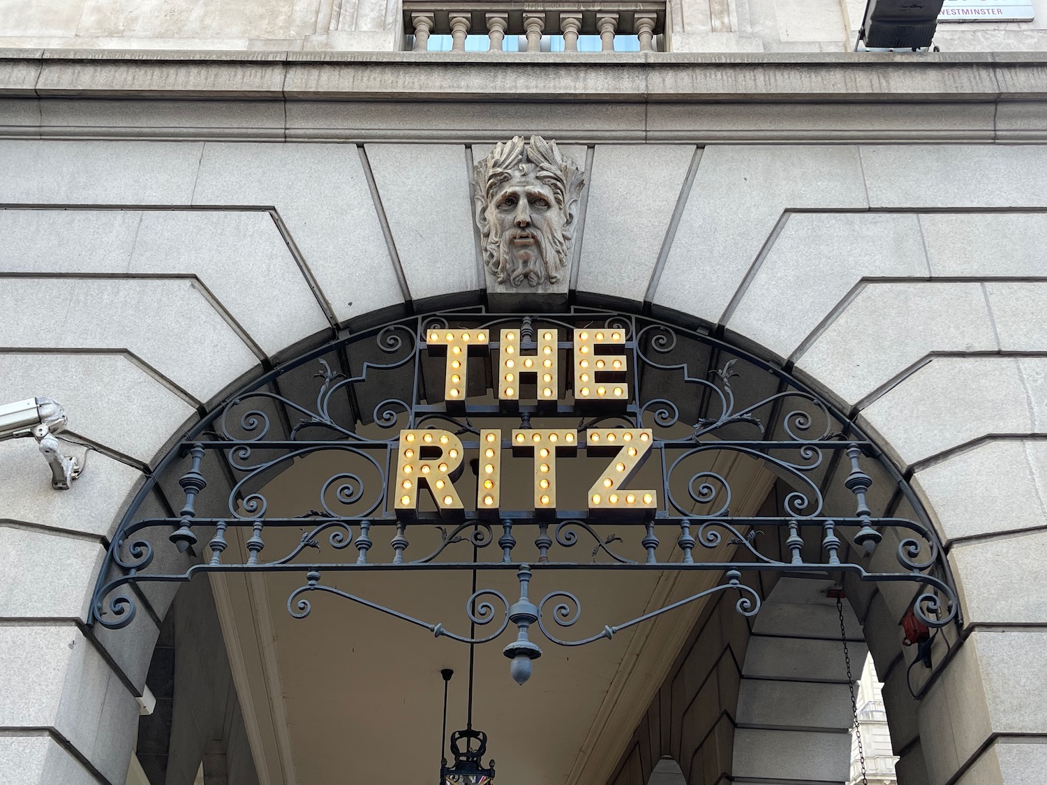 a sign above a stone building