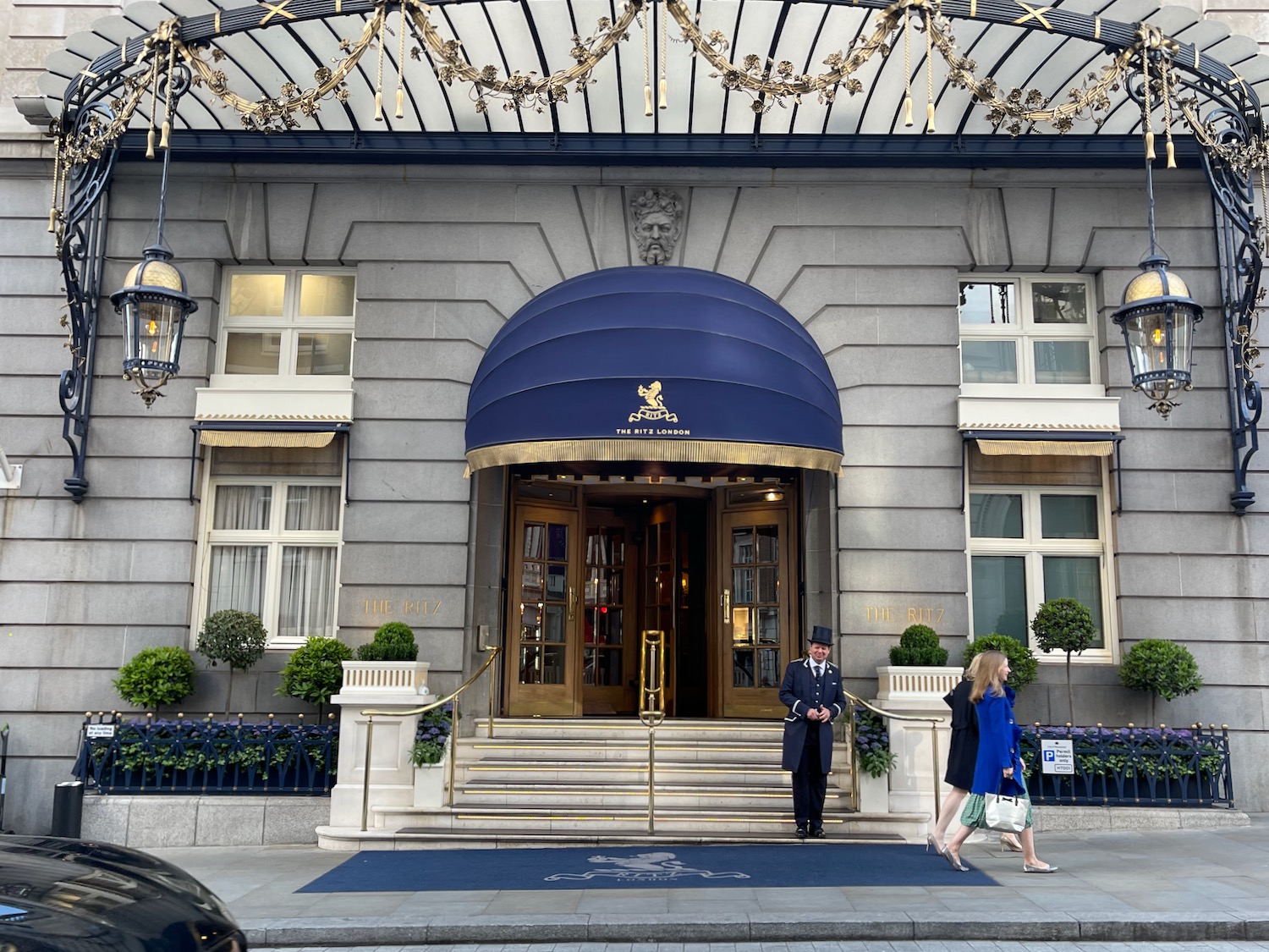 a man and woman walking in front of a building