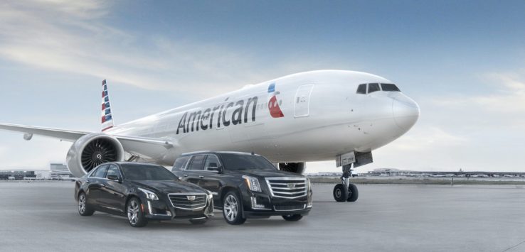 a jet airplane and cars parked on a runway